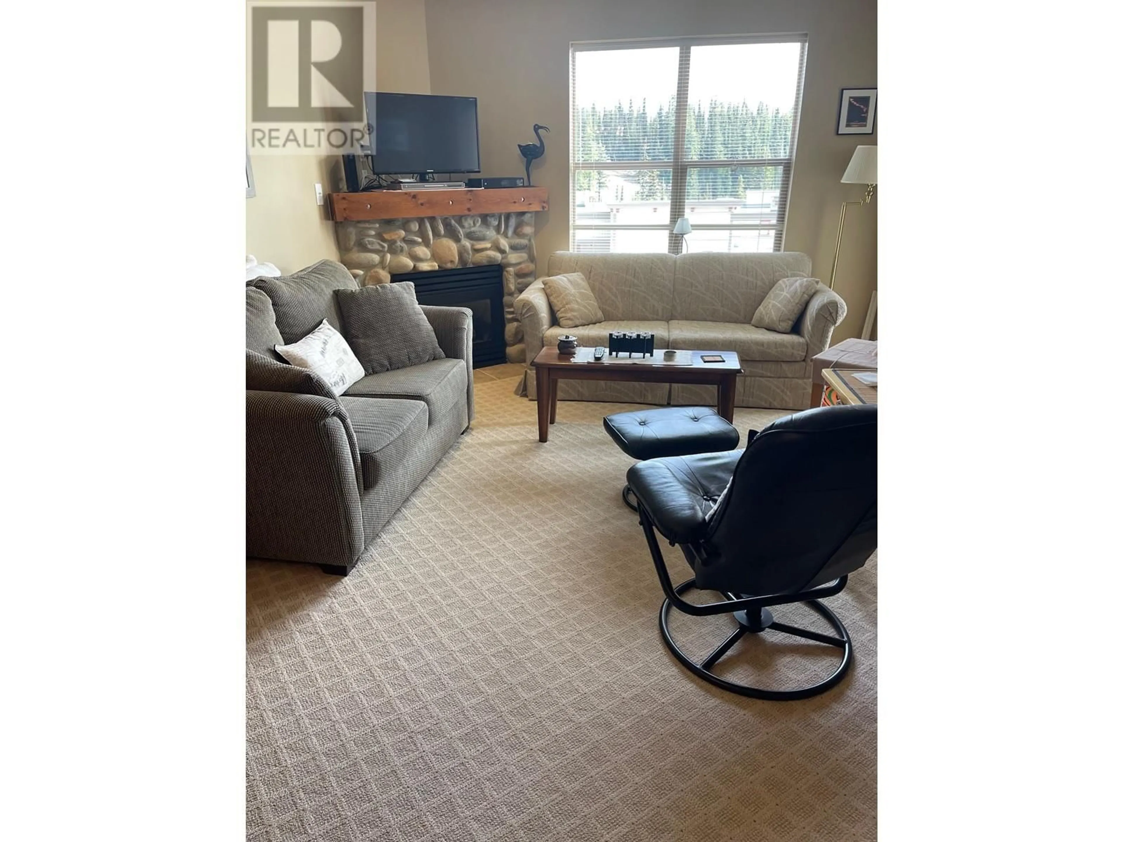 Living room with furniture, carpet floor for 9802 Silver Star Road Unit# 204, Silver Star British Columbia V1B3M1