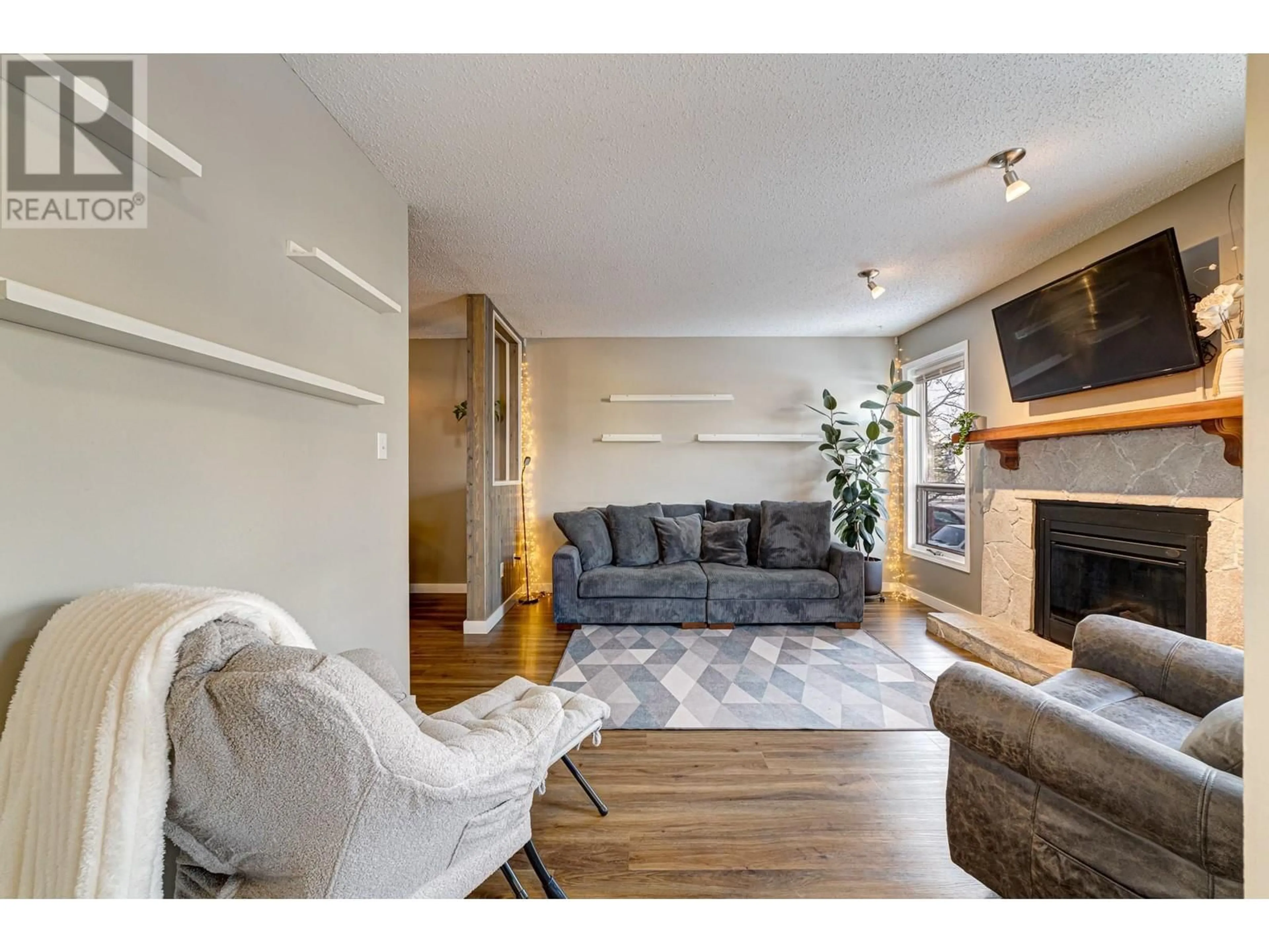 Living room with furniture, wood/laminate floor for 1219 Pinyon Road, Sparwood British Columbia V0B2G2