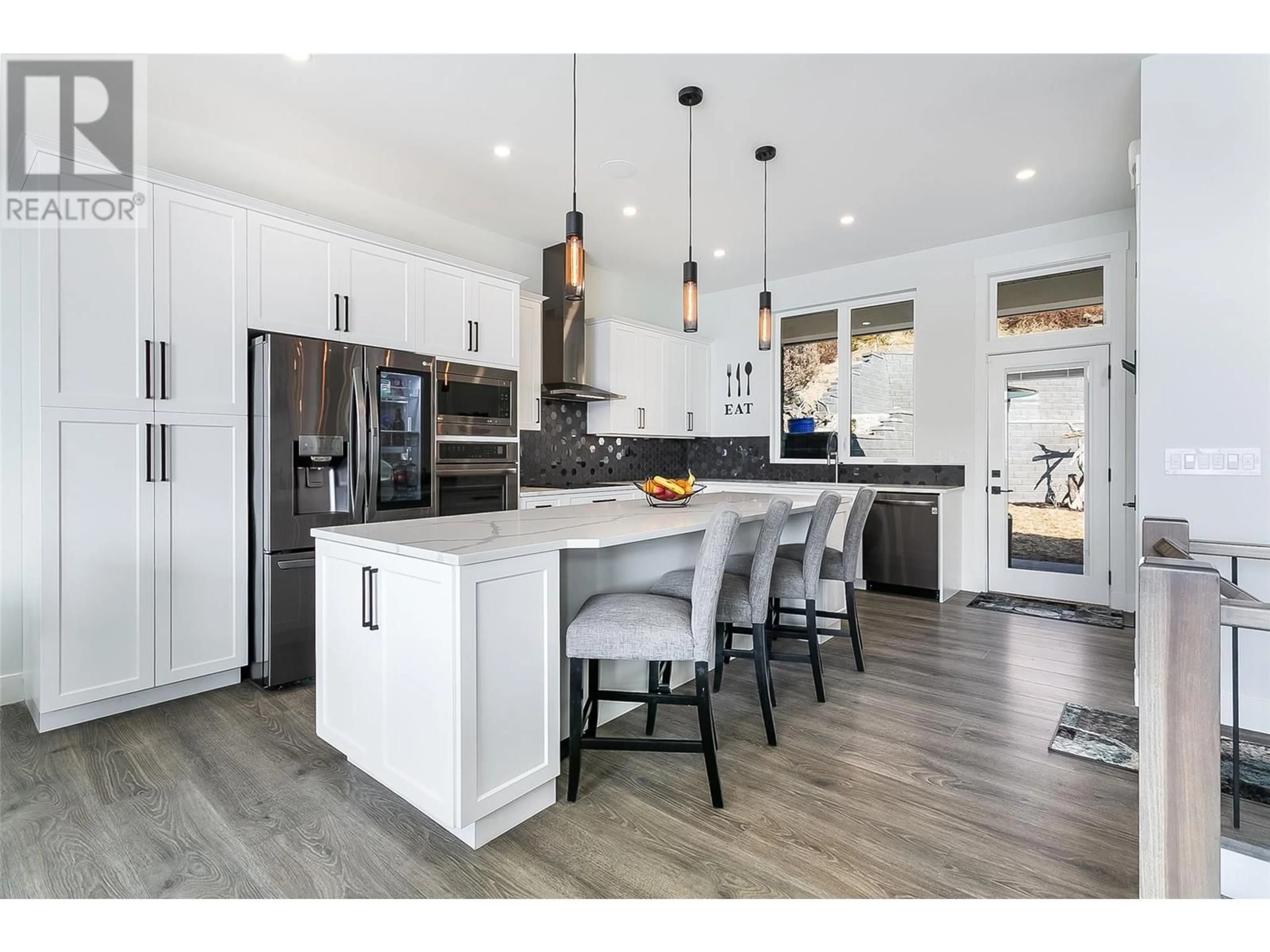 Open concept kitchen, wood/laminate floor for 1296 Menu Road, West Kelowna British Columbia V1Z3K2