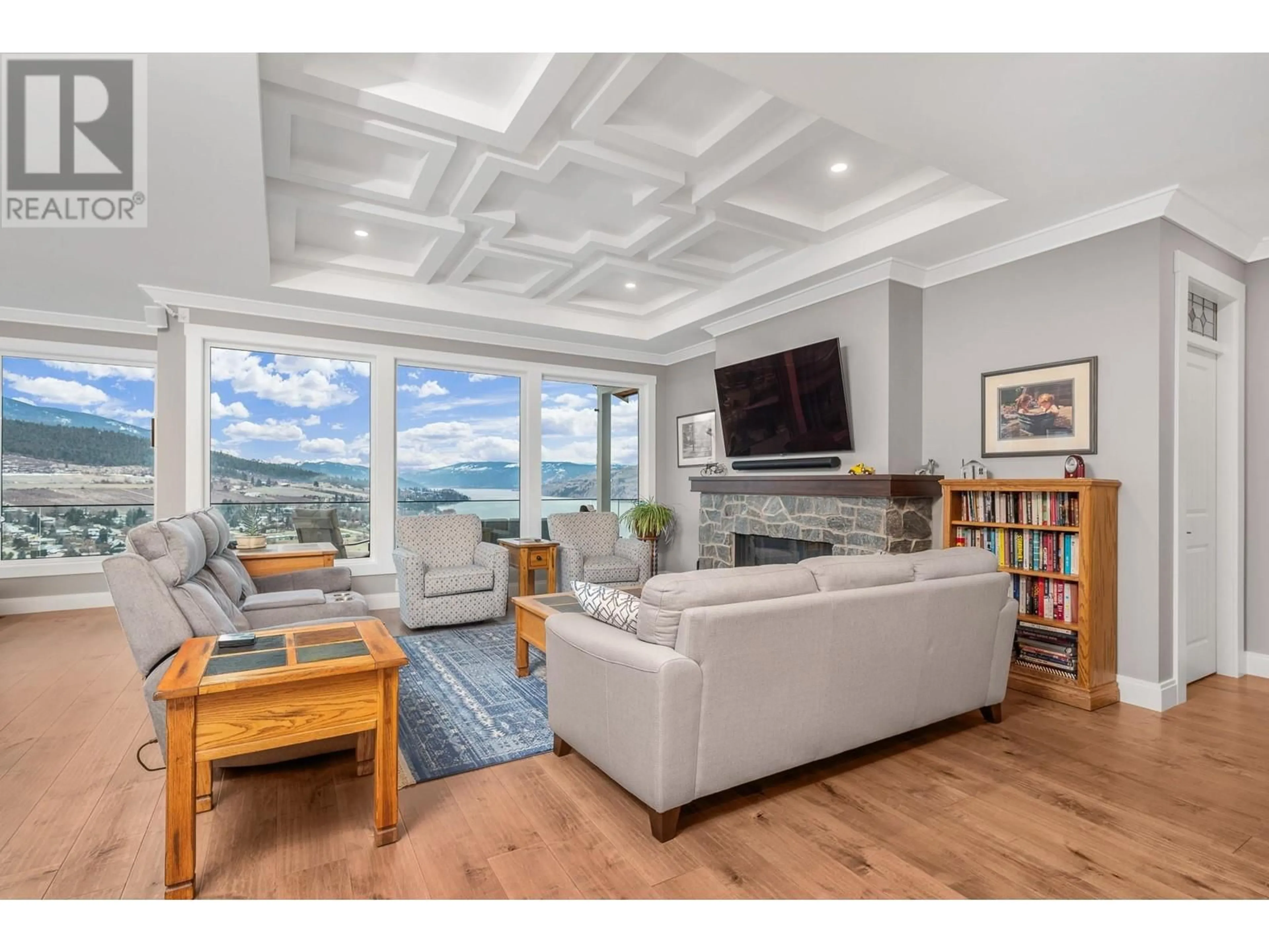 Living room with furniture, wood/laminate floor for 8891 Braeburn Drive, Coldstream British Columbia V1B3W8