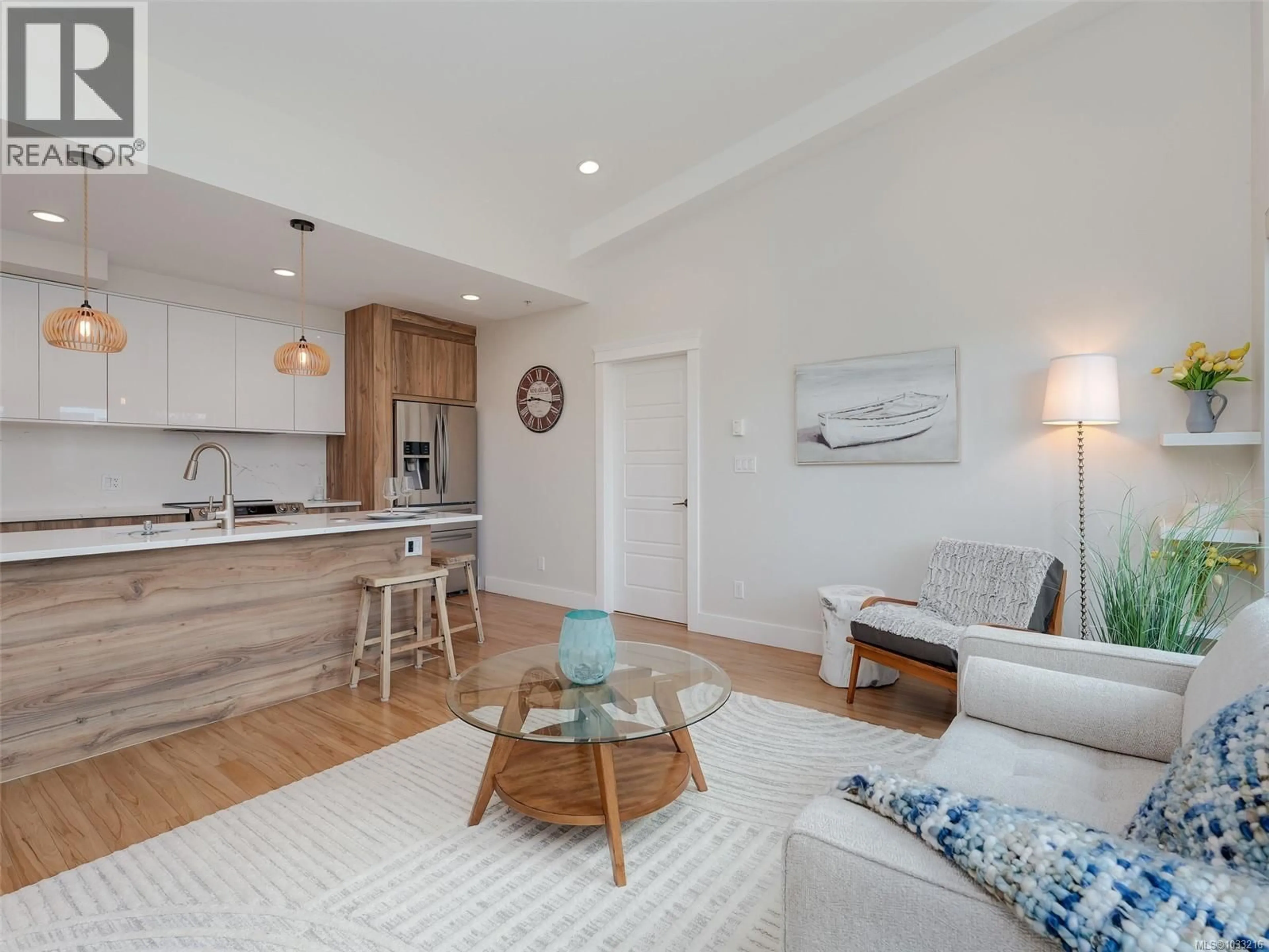 Living room with furniture, wood/laminate floor for 403 - 7161 WEST SAANICH ROAD, Central Saanich British Columbia V8M1P7