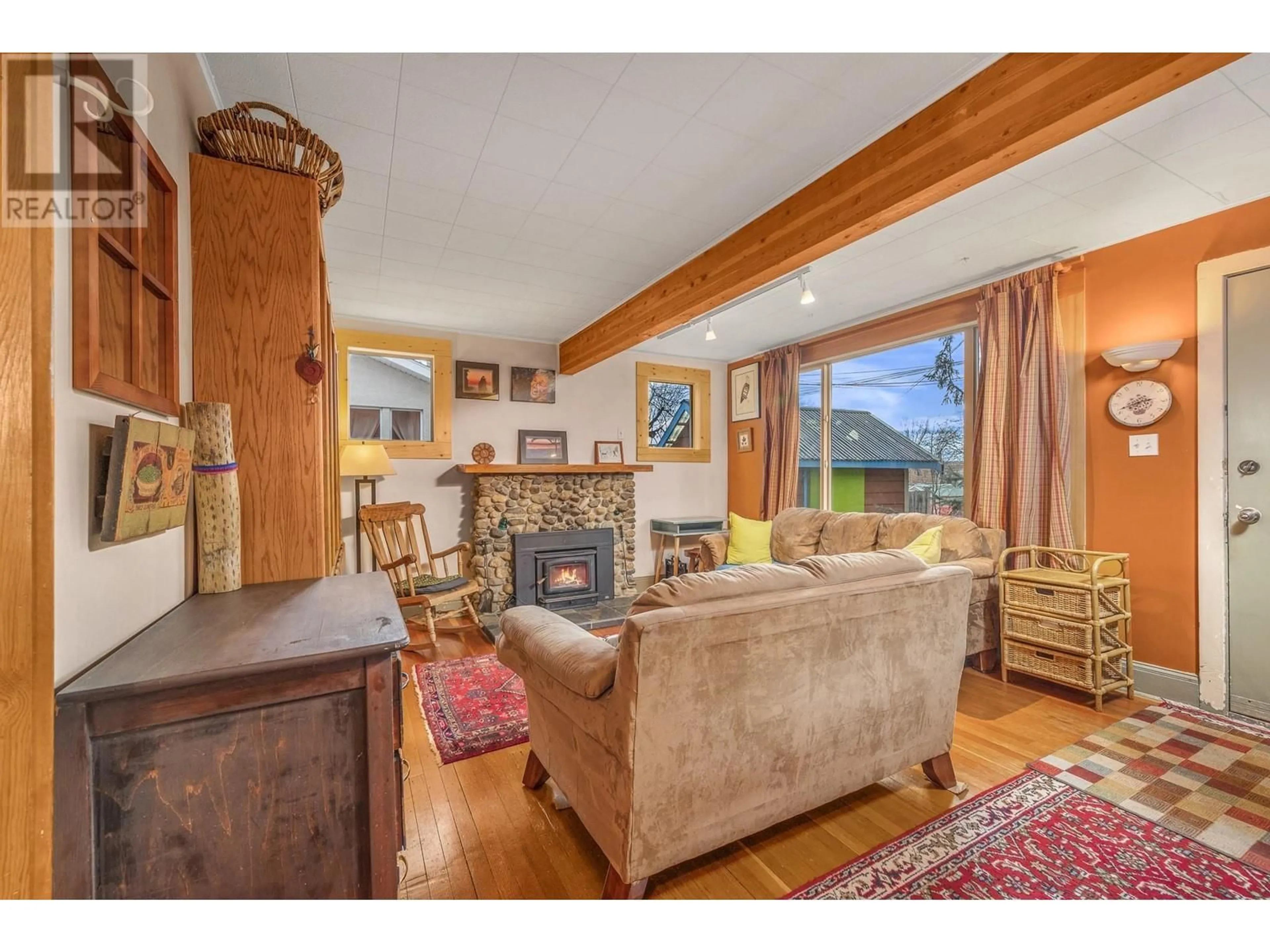 Living room with furniture, wood/laminate floor for 3103 25 Street, Vernon British Columbia V1T4R2