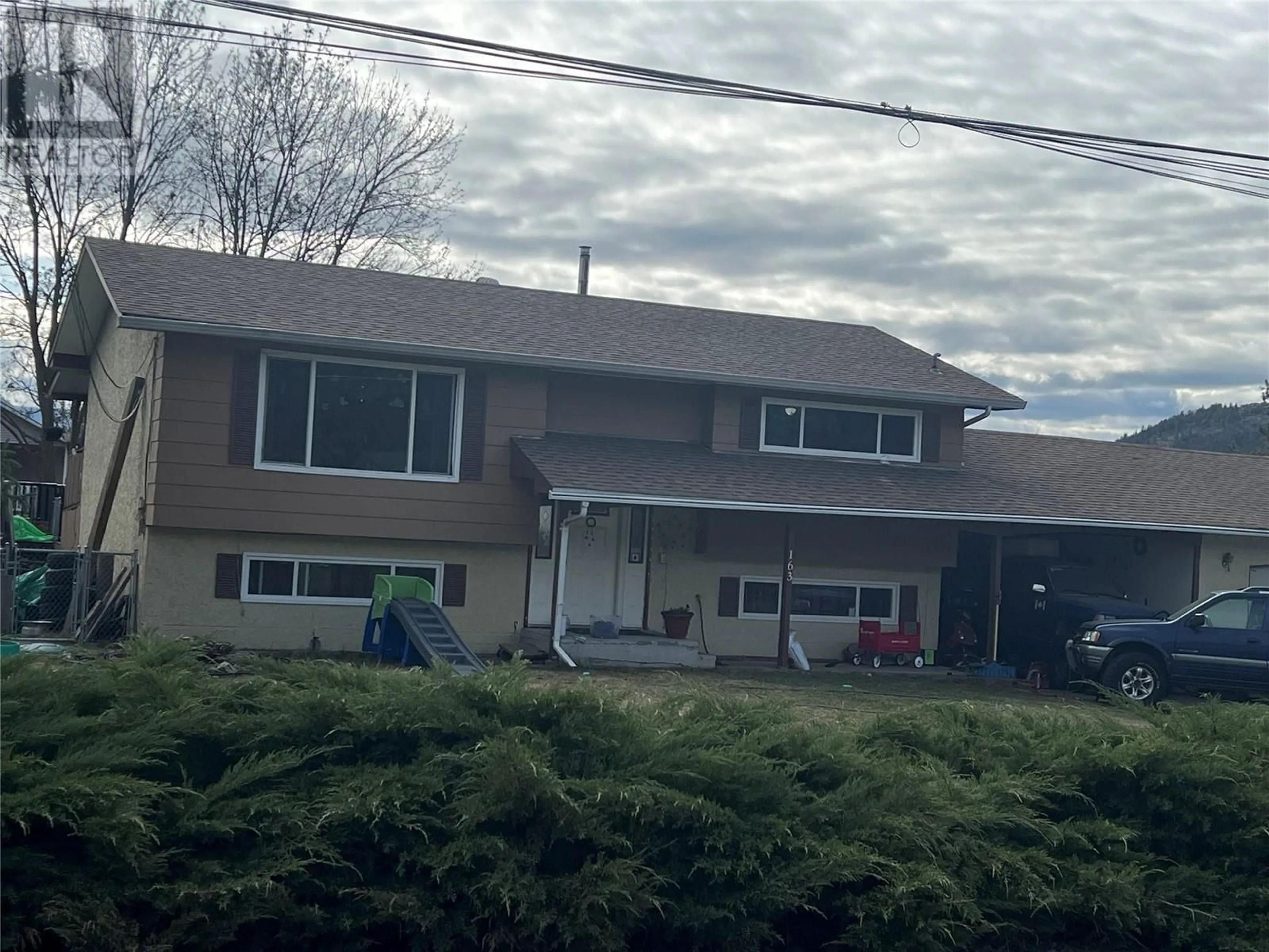 A pic from outside/outdoor area/front of a property/back of a property/a pic from drone, street for 163 CARIBOO ROAD, Kelowna British Columbia V1V2E4