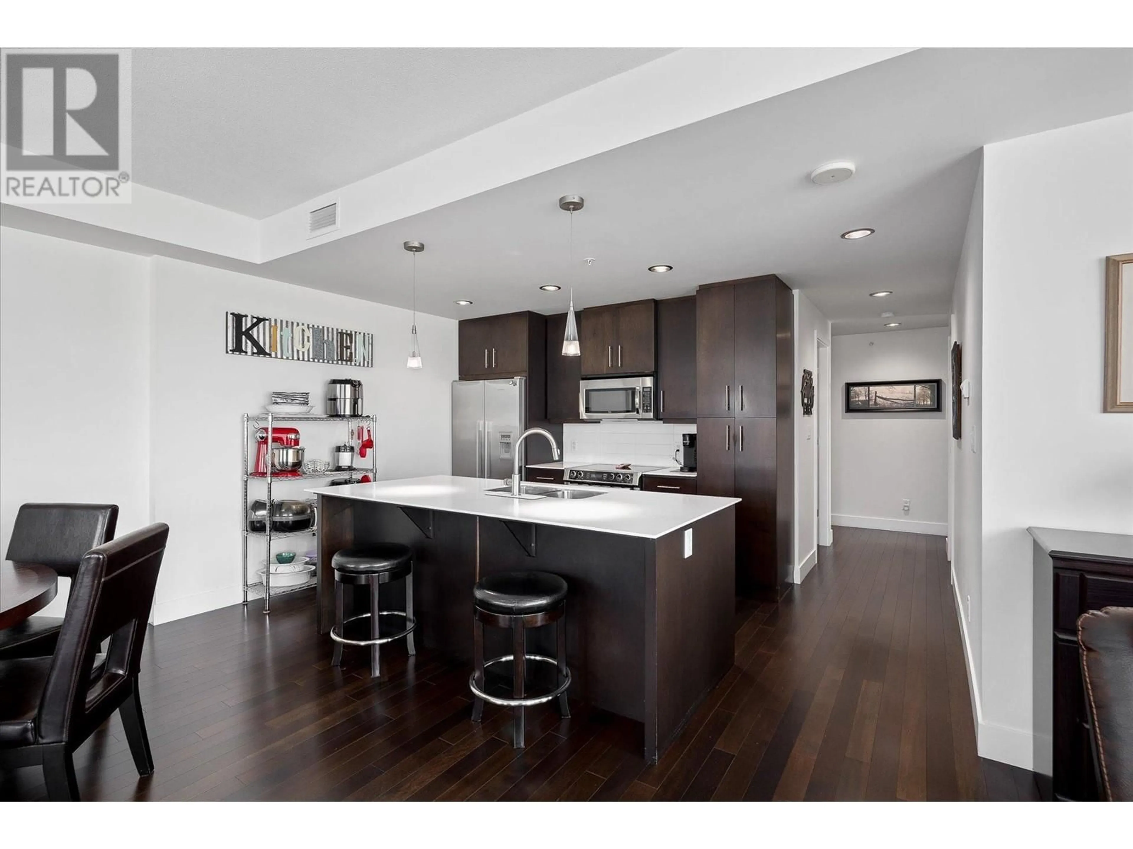 Open concept kitchen, wood/laminate floor for 2040 Springfield Road Unit# 906, Kelowna British Columbia V1Y9N7