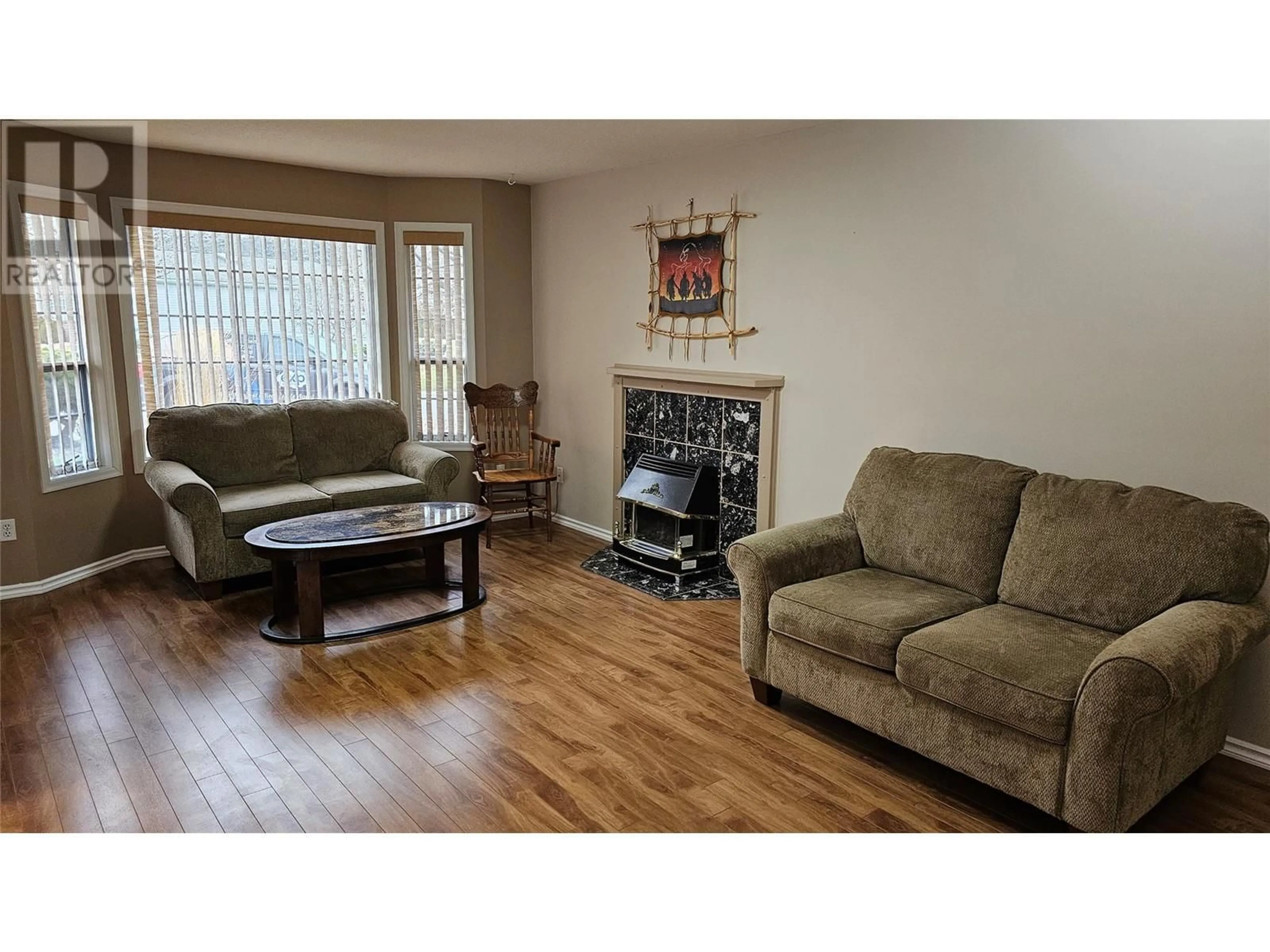 Living room with furniture, wood/laminate floor for 221 Sandpiper Crescent, Penticton British Columbia V2A8K6