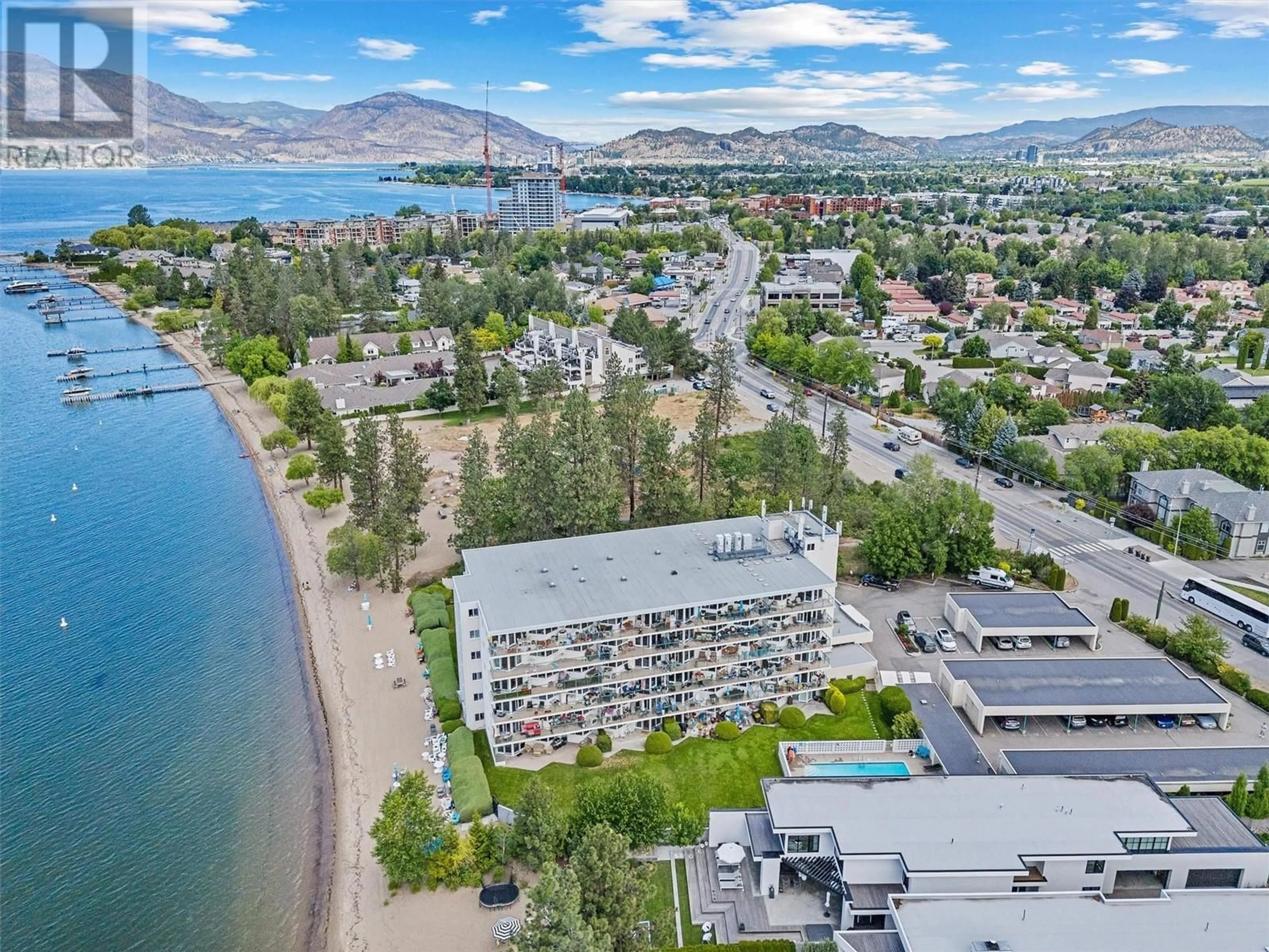 A pic from outside/outdoor area/front of a property/back of a property/a pic from drone, water/lake/river/ocean view for 4058 Lakeshore Road Unit# 202, Kelowna British Columbia V1W1V6