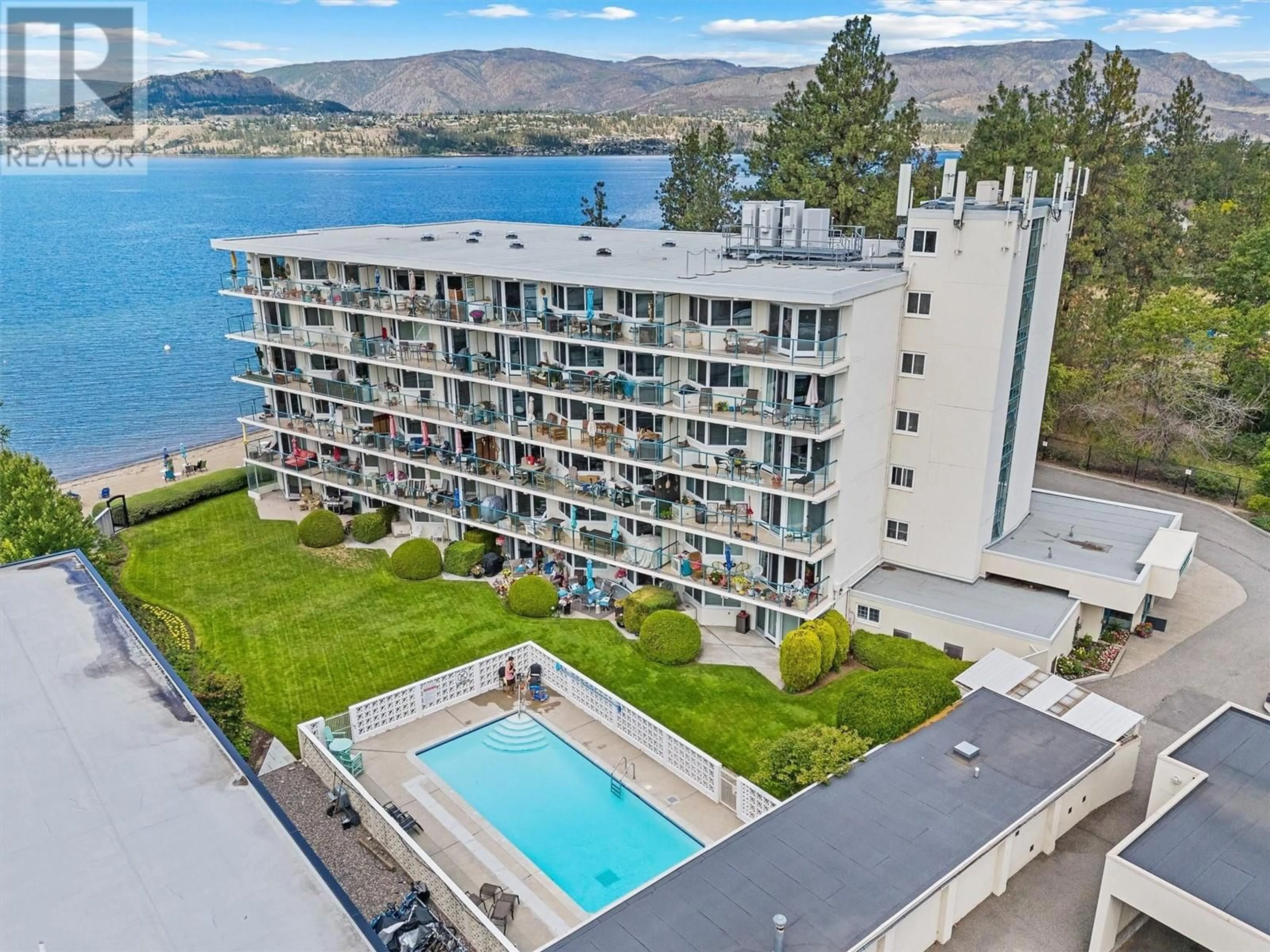 A pic from outside/outdoor area/front of a property/back of a property/a pic from drone, water/lake/river/ocean view for 4058 Lakeshore Road Unit# 202, Kelowna British Columbia V1W1V6