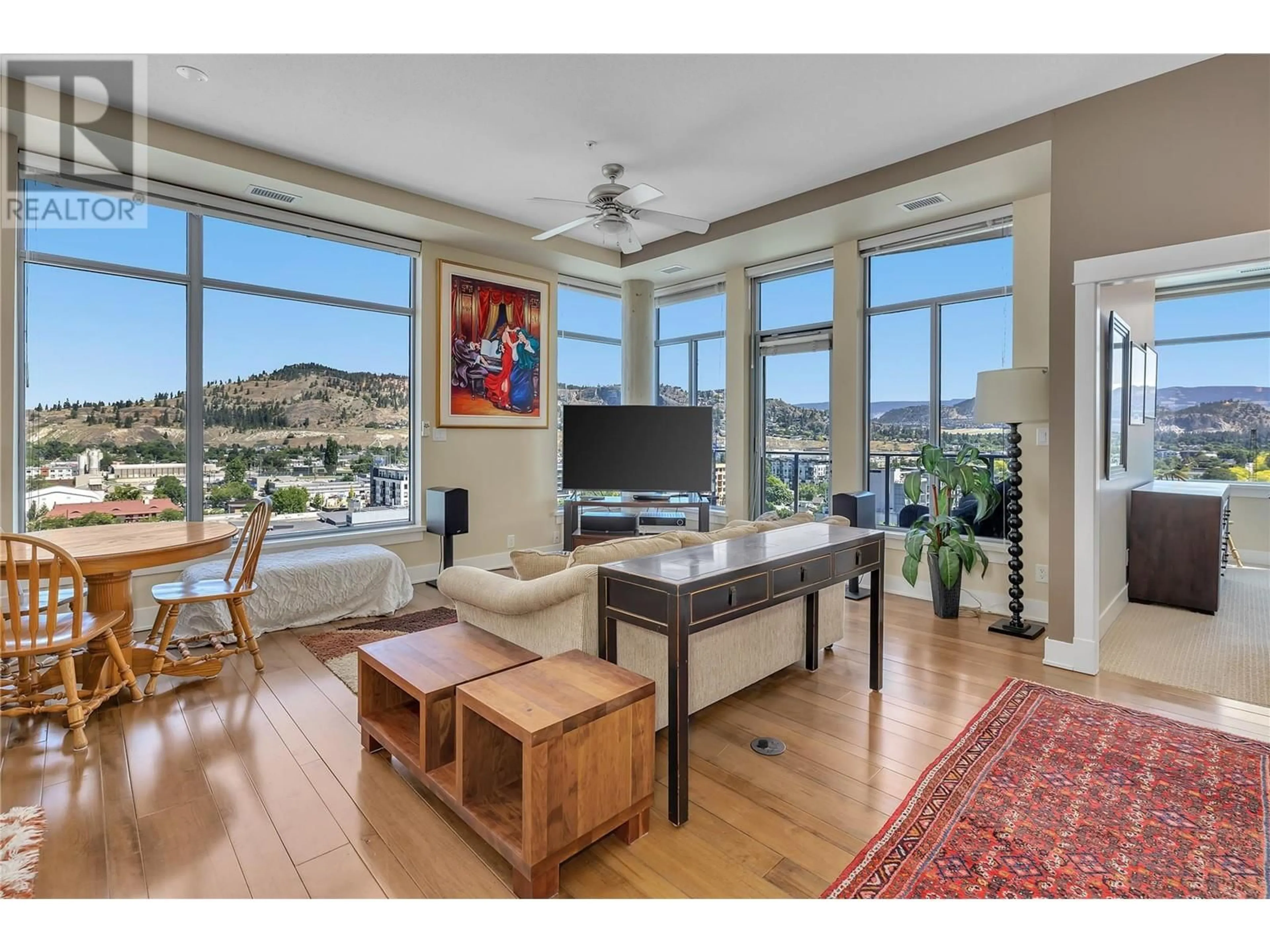 Living room with furniture, wood/laminate floor for 1329 Ellis Street Unit# 1005, Kelowna British Columbia V1Y9X5