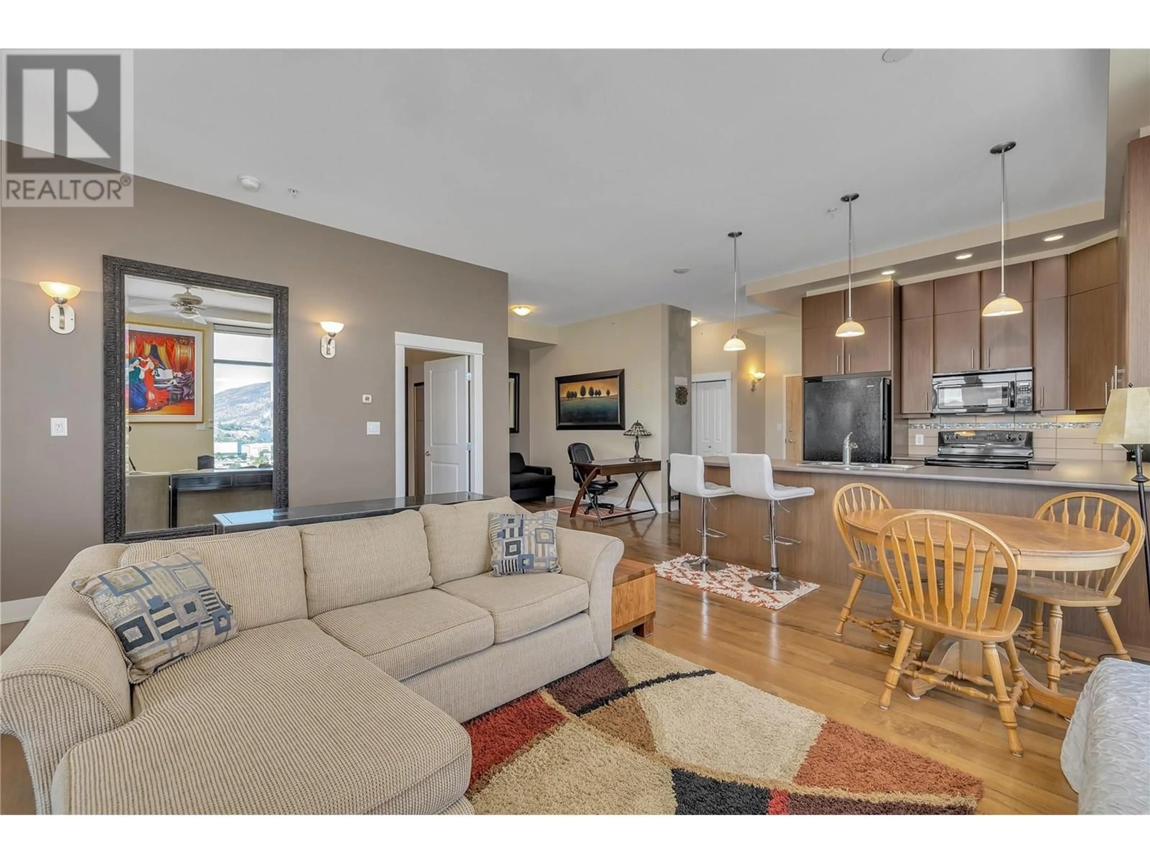 Living room with furniture, wood/laminate floor for 1329 Ellis Street Unit# 1005, Kelowna British Columbia V1Y9X5