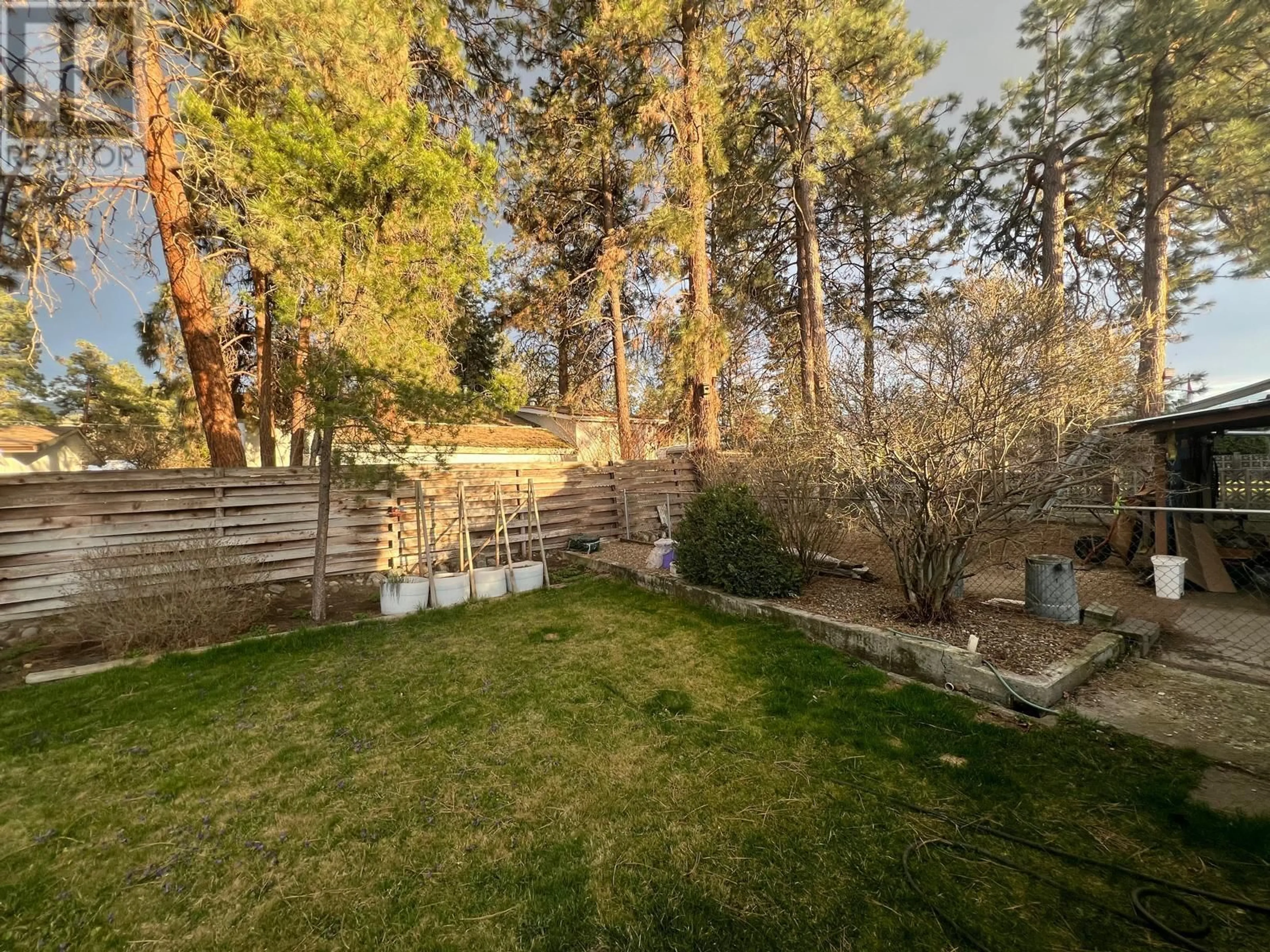 A pic from outside/outdoor area/front of a property/back of a property/a pic from drone, forest/trees view for 225 Cambie Road, Kelowna British Columbia V1X3H9