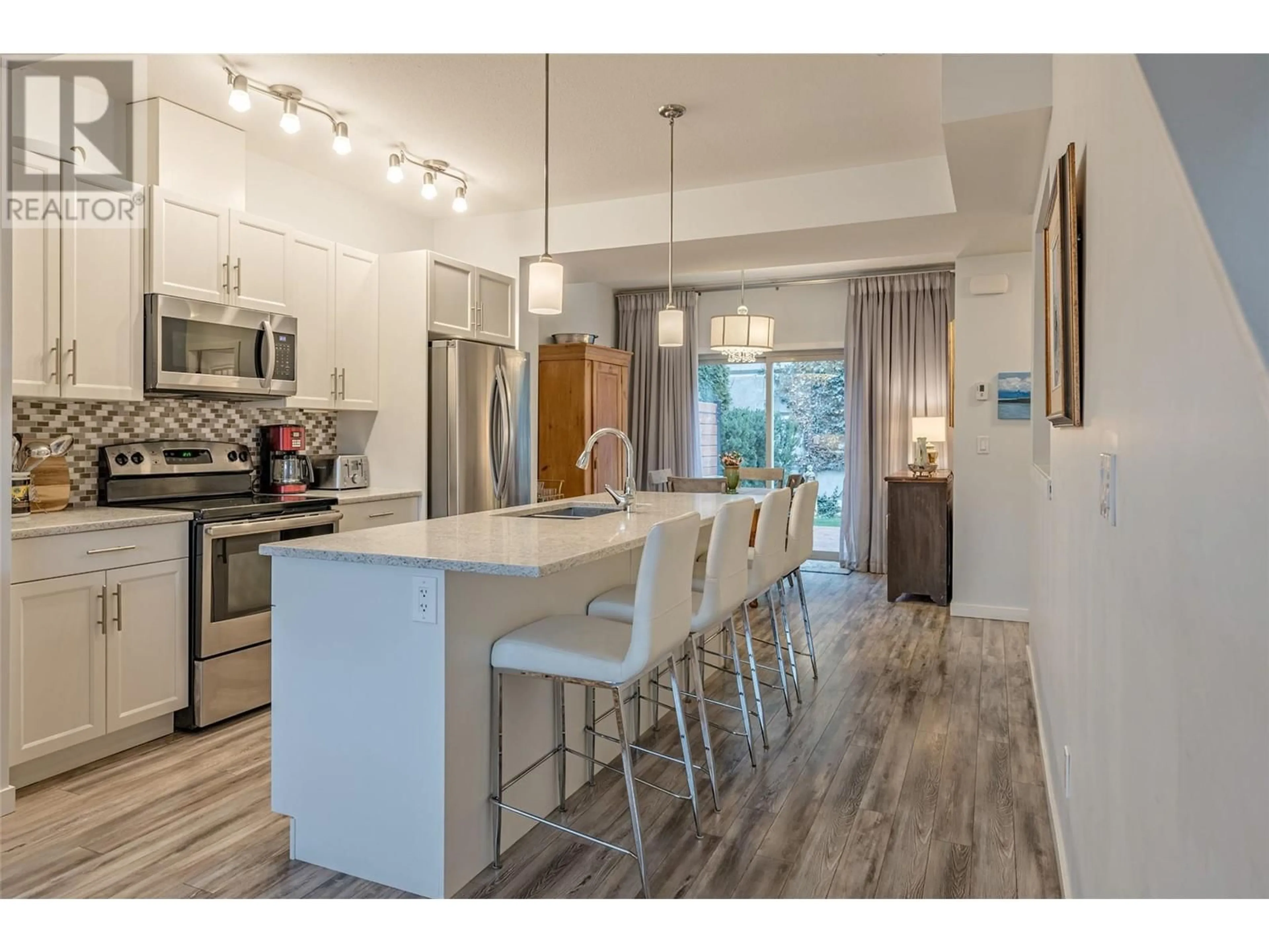 Open concept kitchen, wood/laminate floor for 4700 Okanagan Avenue Unit# 18, Vernon British Columbia V1T9Y7