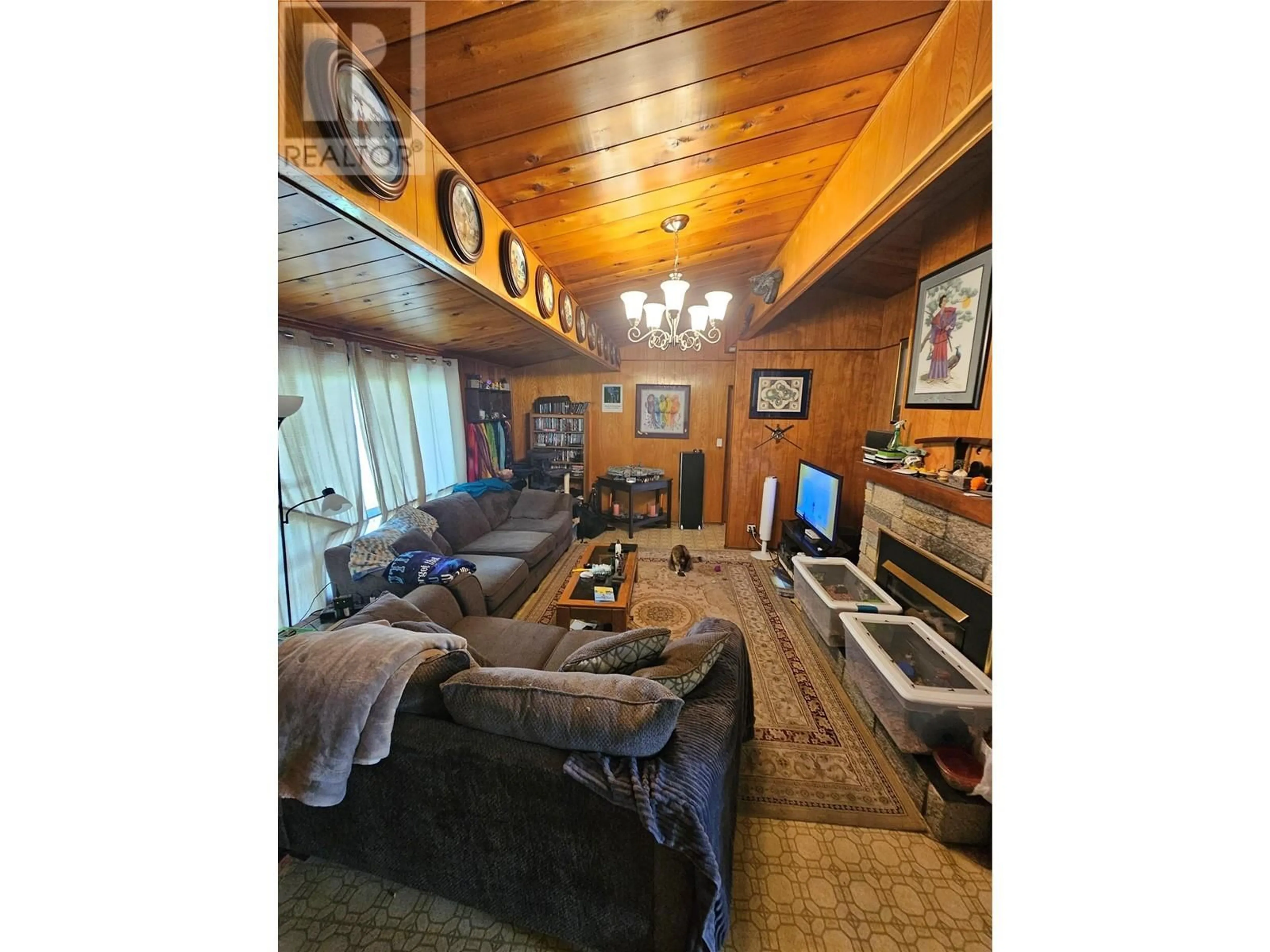 Living room with furniture, wood/laminate floor for 215 Cambie Road, Kelowna British Columbia V1X3H9