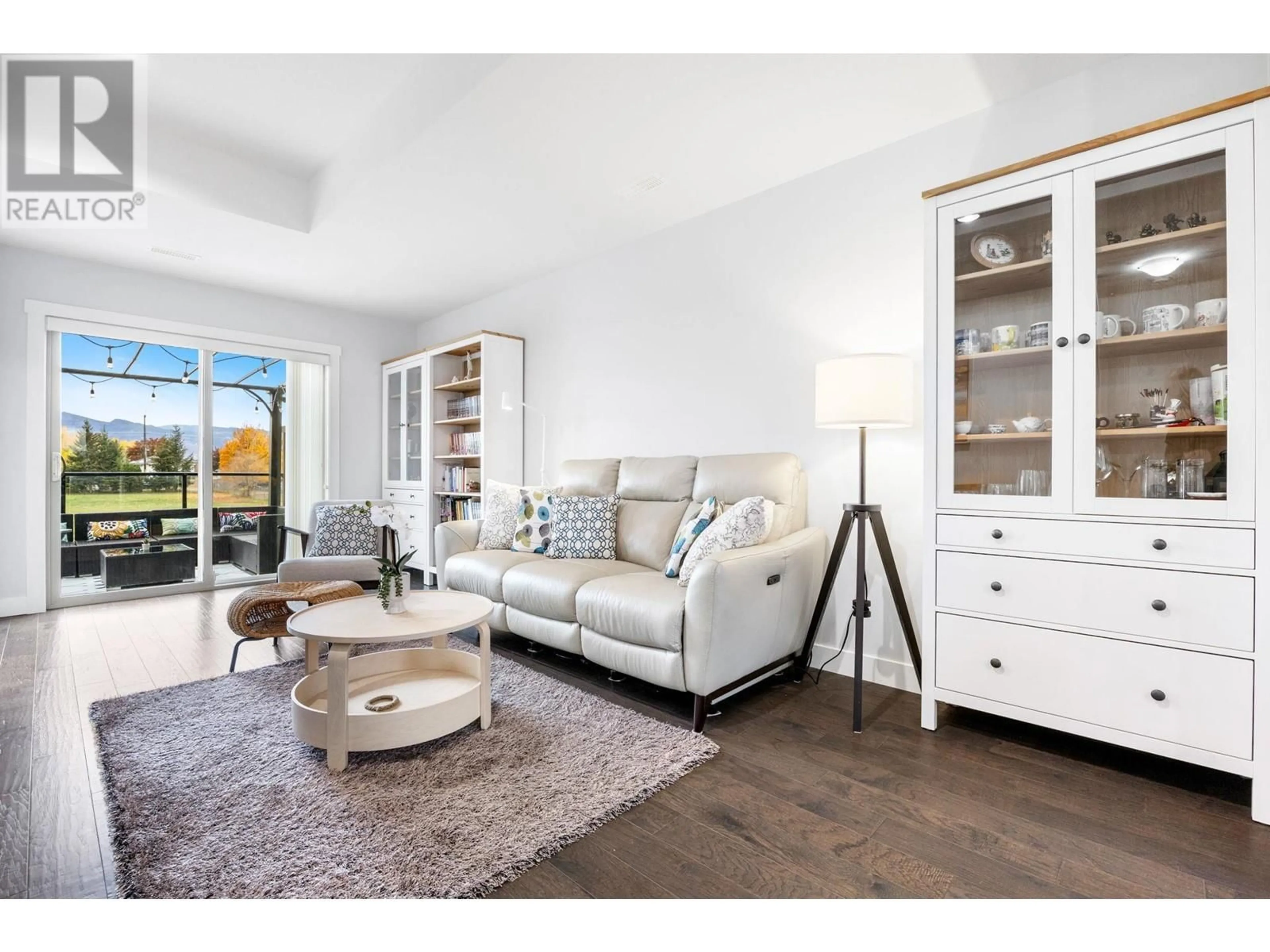 Living room with furniture, wood/laminate floor for 3626 Mission Springs Drive Unit# 47, Kelowna British Columbia V1W5L1