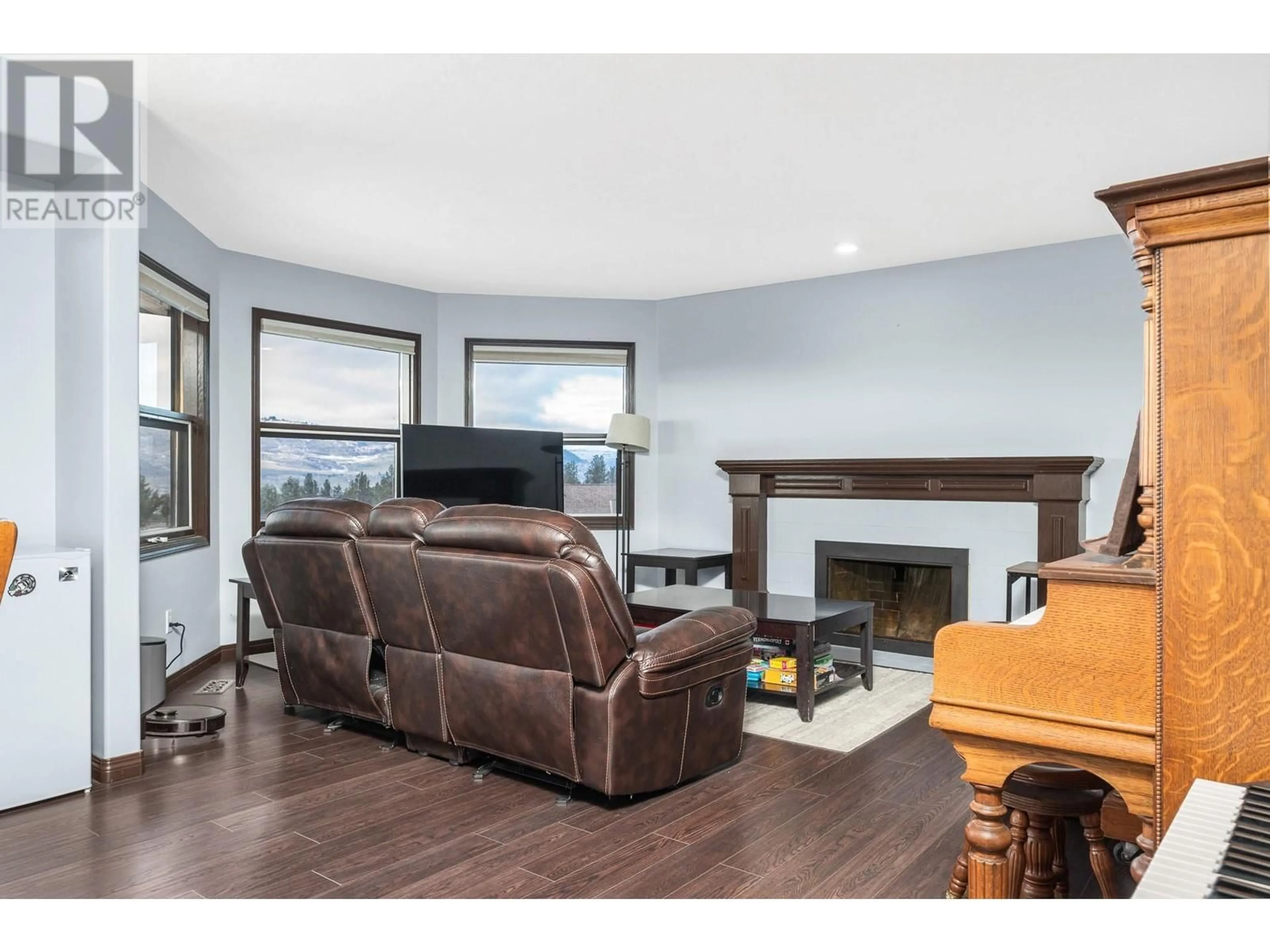 Living room with furniture, wood/laminate floor for 4317 Wellington Drive, Vernon British Columbia V1T9A6