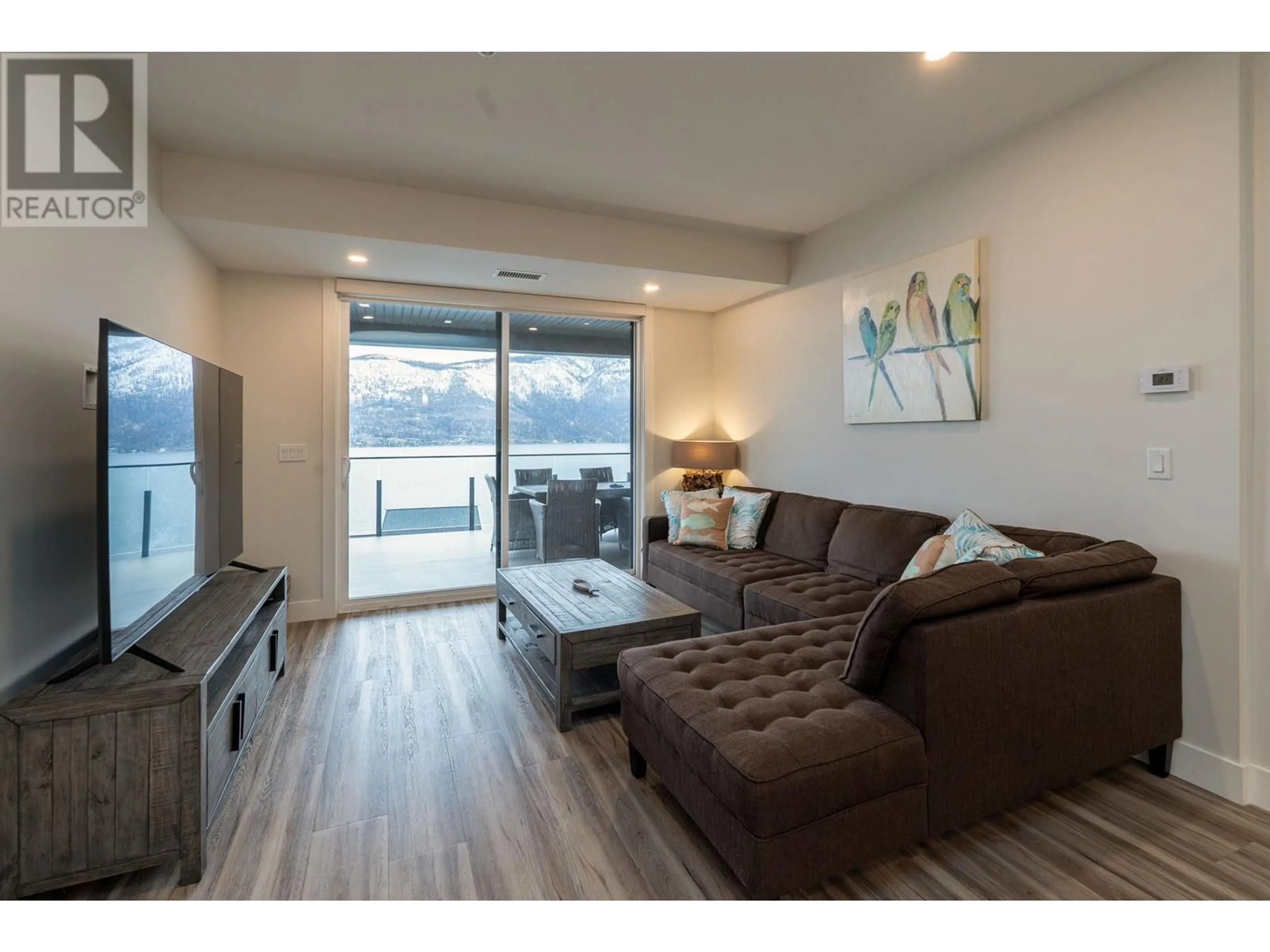 Living room with furniture, wood/laminate floor for 3475 Granite Close Unit# 312, Kelowna British Columbia V1V0B9