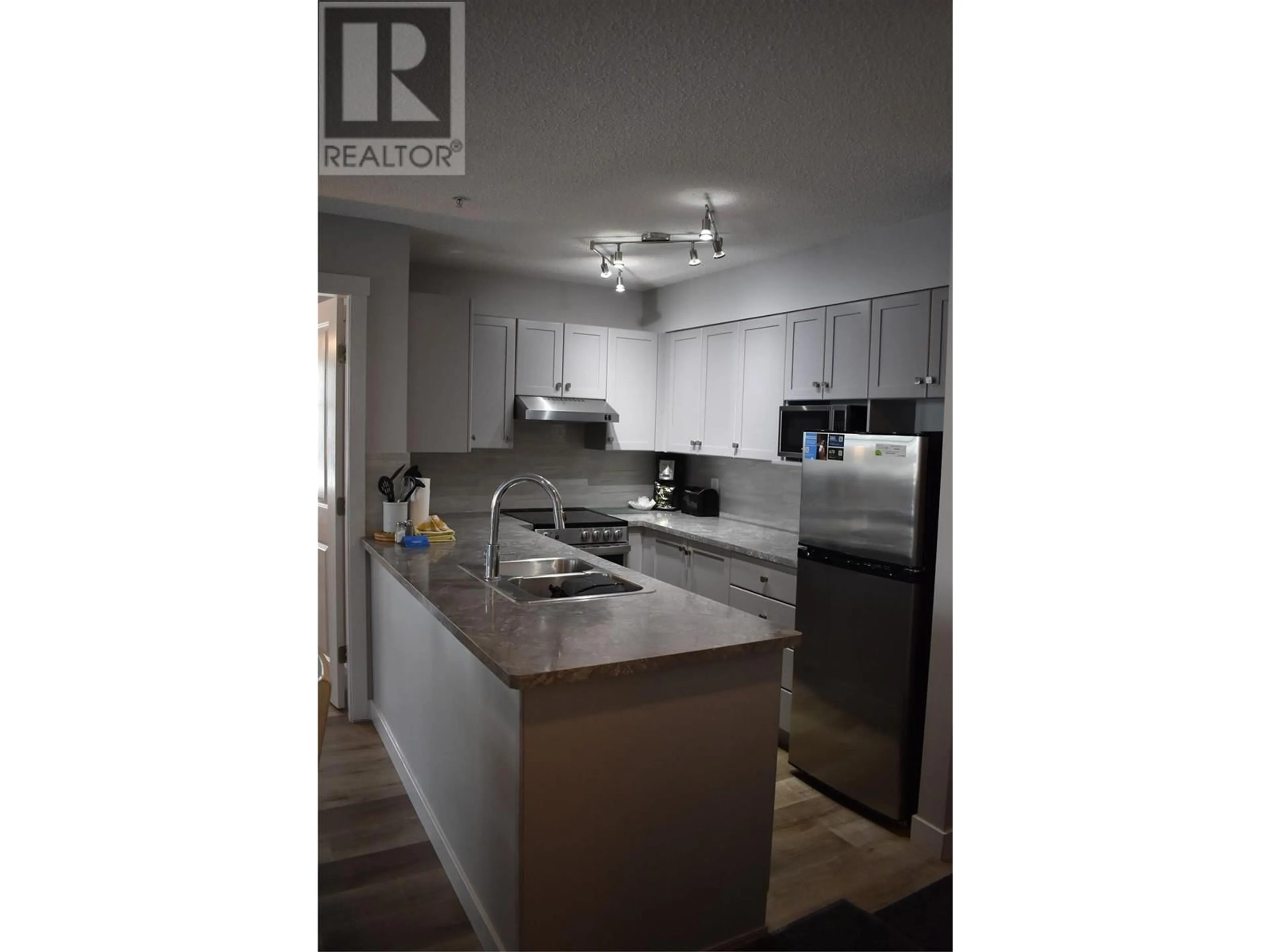 Open concept kitchen, wood/laminate floor for 2060 SUMMIT Drive Unit# 214, Panorama British Columbia V0A1T0