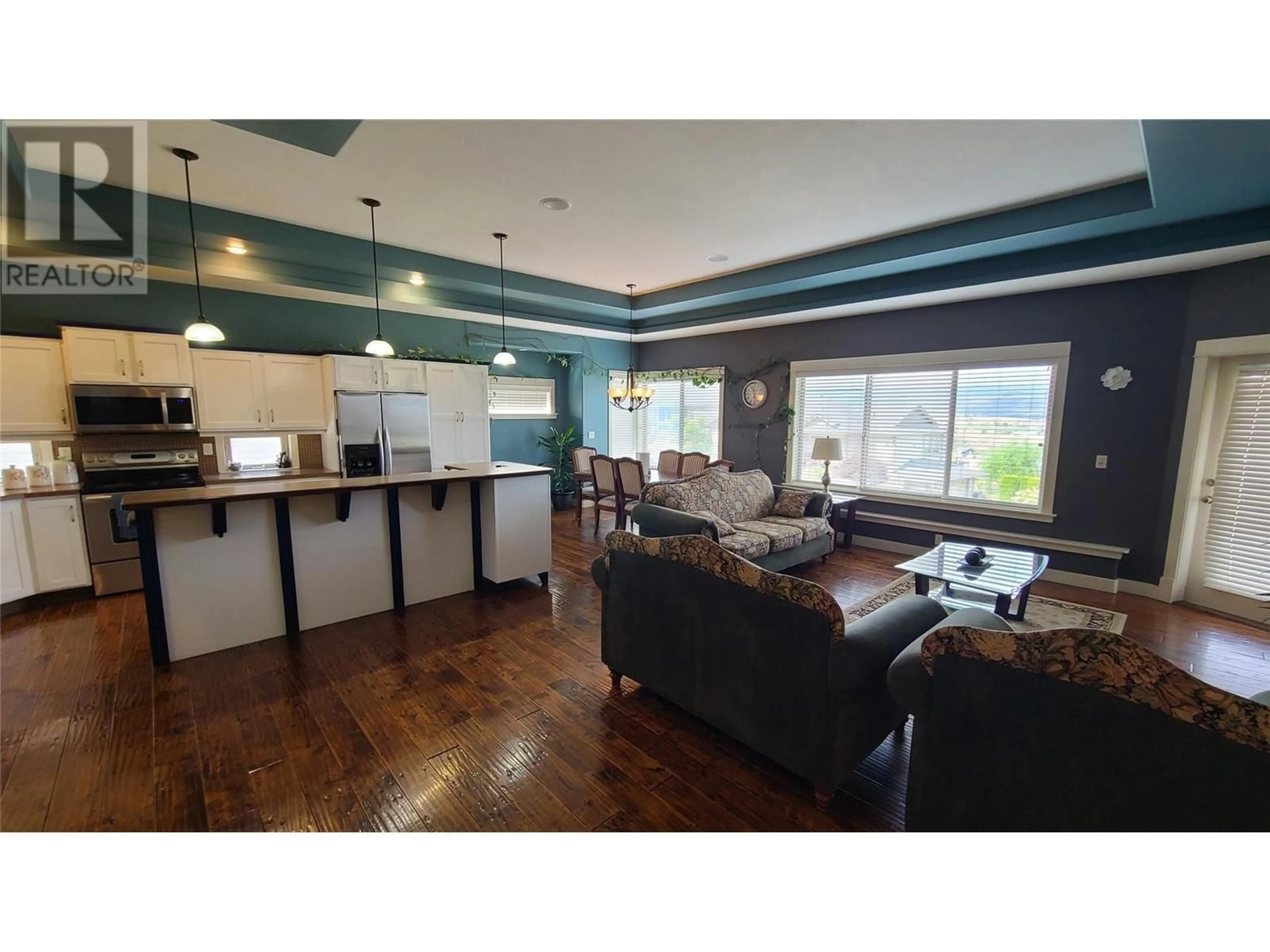 Open concept kitchen, wood/laminate floor for 1047 Mt Ida Drive, Vernon British Columbia V1B4A7