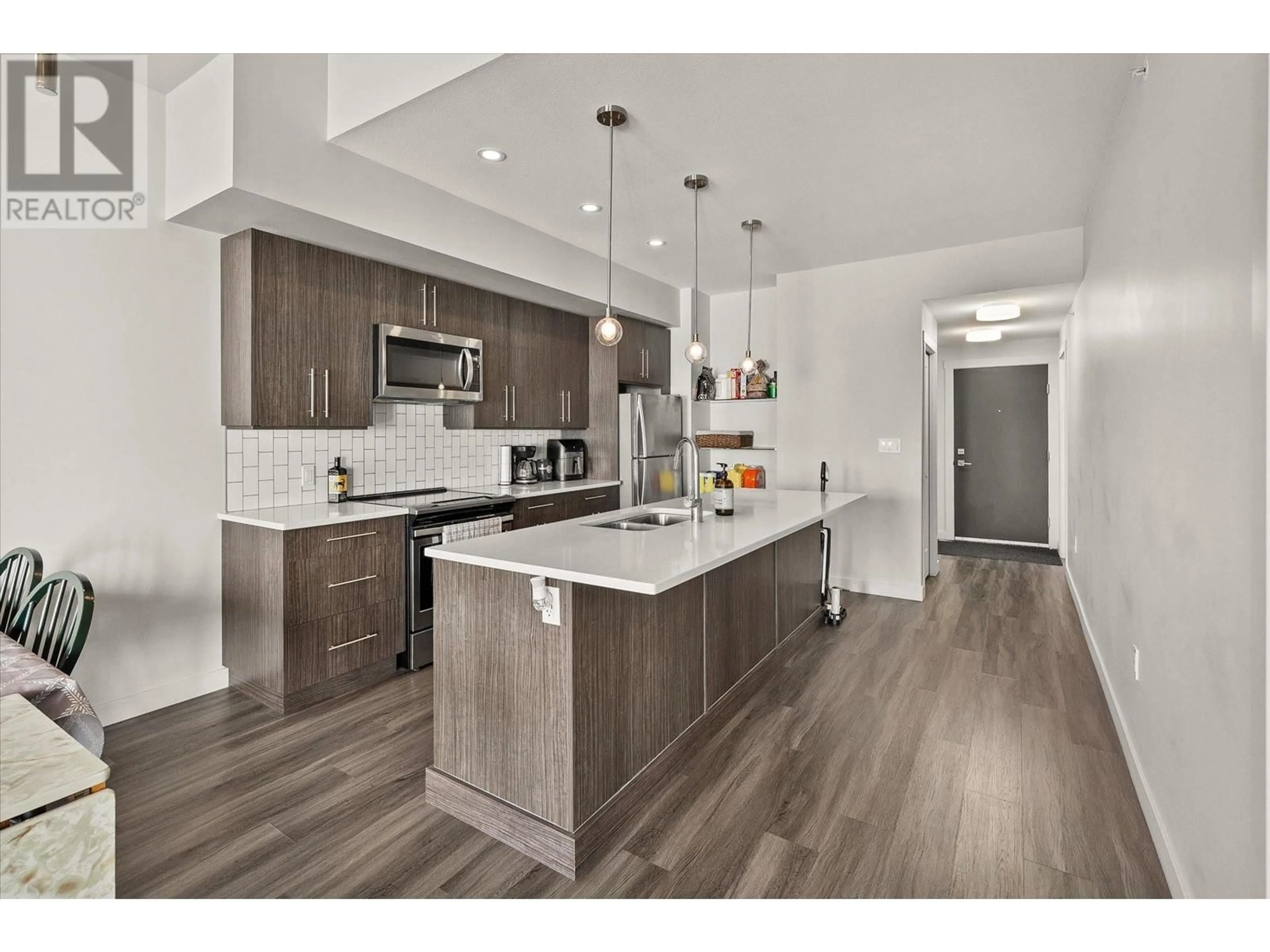 Open concept kitchen, wood/laminate floor for 3638 Mission Springs Drive Unit# 505, Kelowna British Columbia V1W0B3