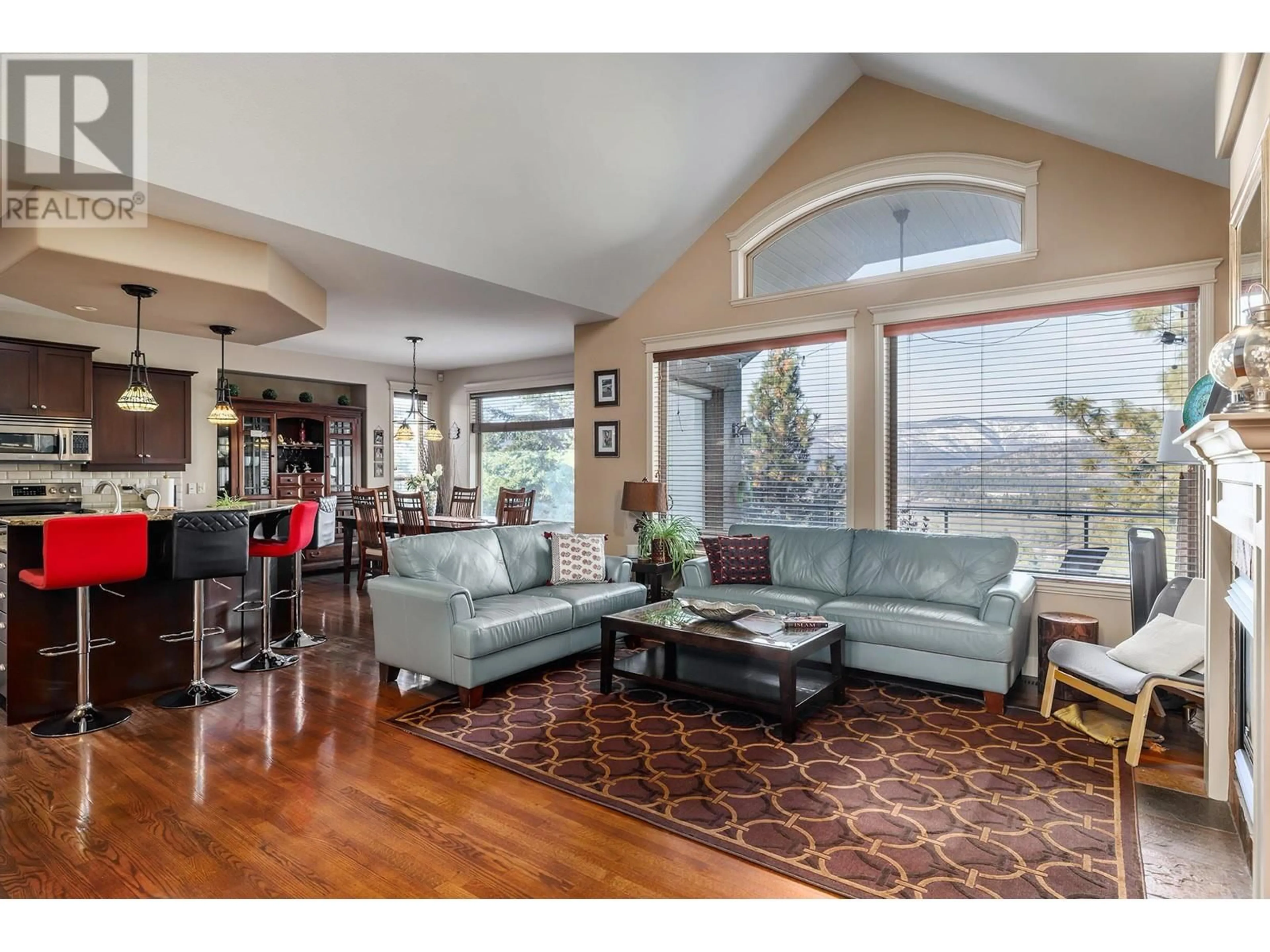 Living room with furniture, wood/laminate floor for 2222 Quail Run Drive, Kelowna British Columbia V1V2S4