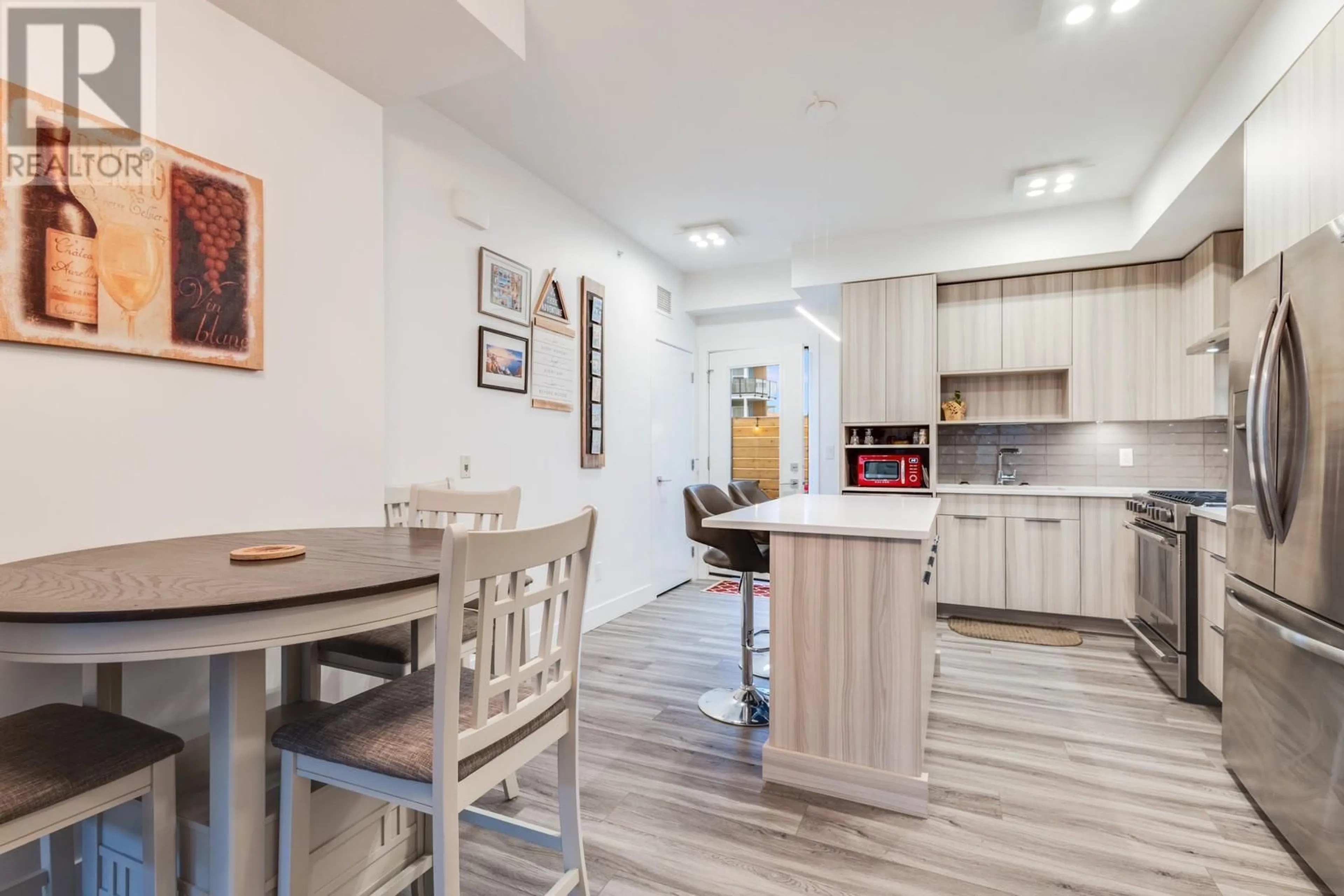 Open concept kitchen, wood/laminate floor for 101 - 3634 MISSION SPRINGS DRIVE, Kelowna British Columbia V1W0C9