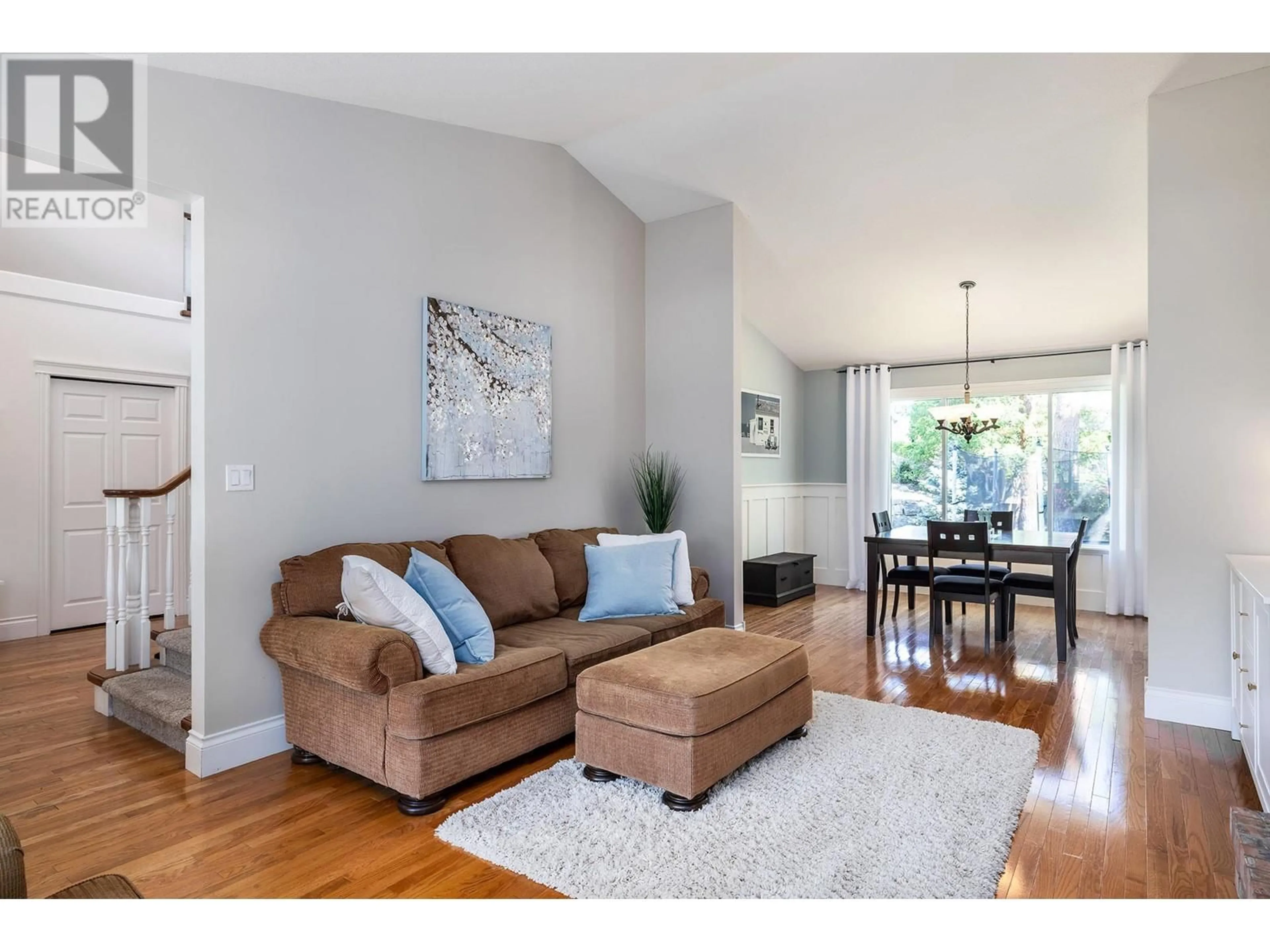 Living room with furniture, wood/laminate floor for 480 CURLEW DRIVE, Kelowna British Columbia V1W4L1