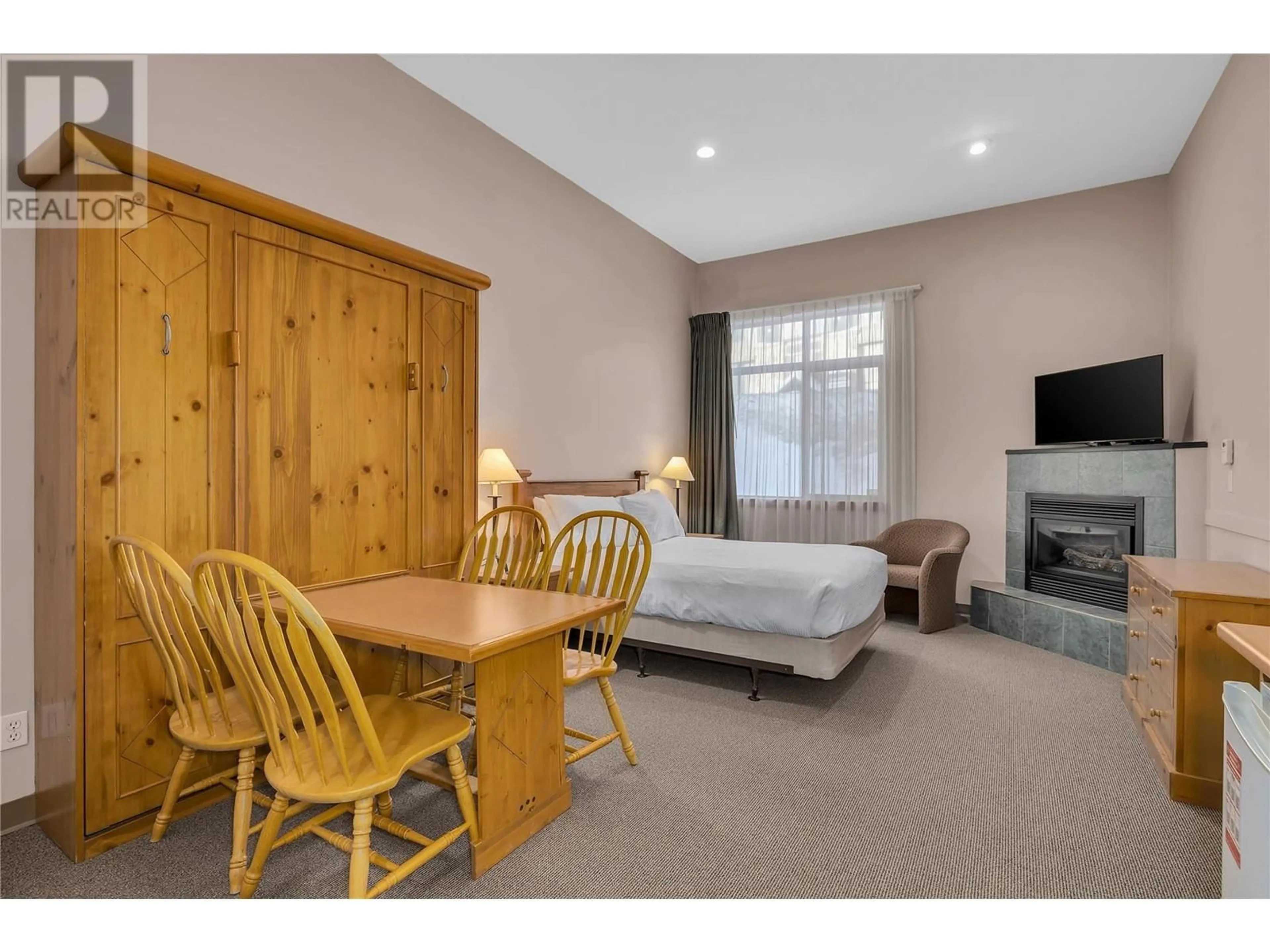 Living room with furniture, wood/laminate floor for 121 - 5340 BIG WHITE ROAD, Big White British Columbia V1P1P3