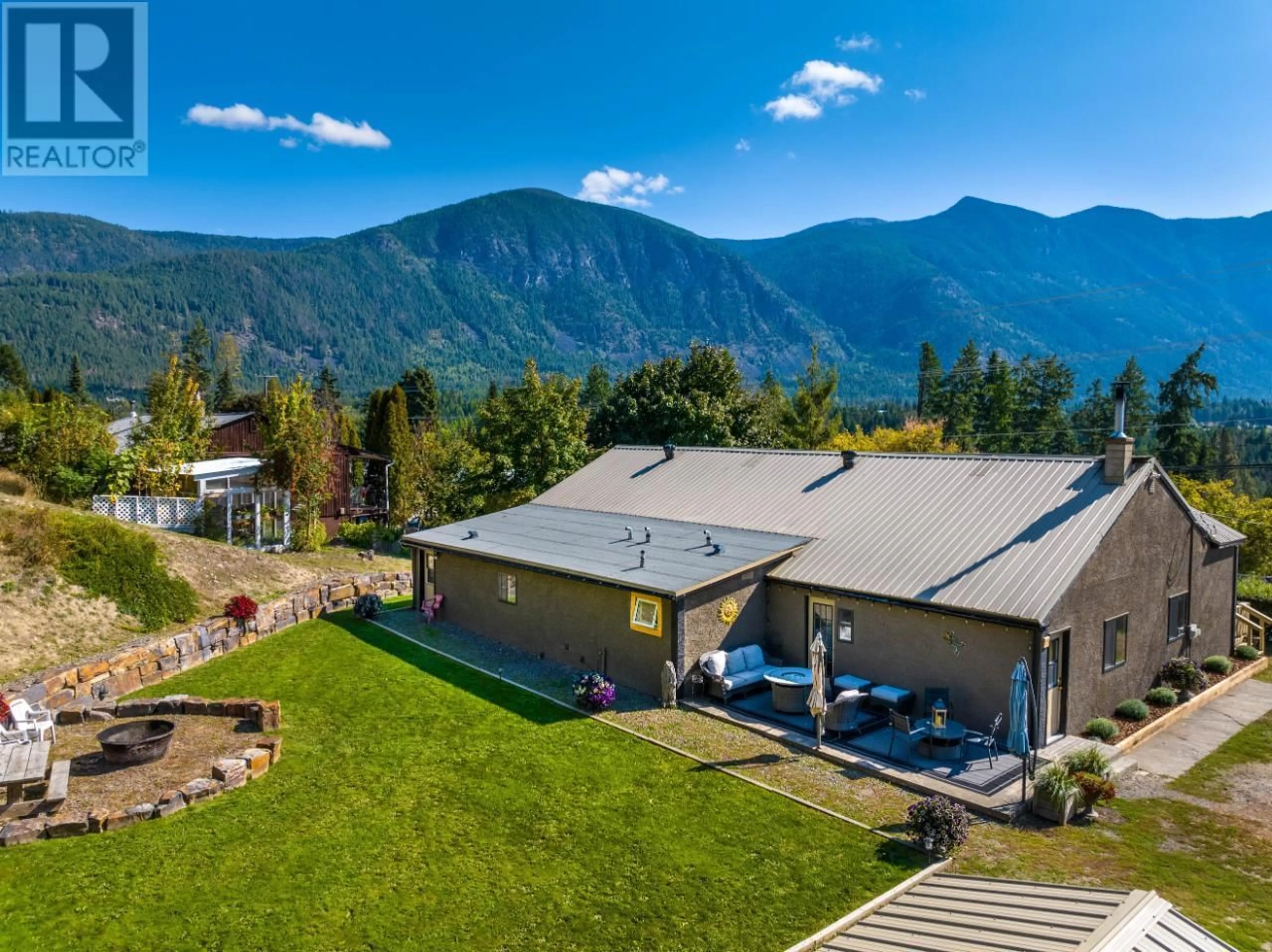 A pic from outside/outdoor area/front of a property/back of a property/a pic from drone, mountain view for 3706 3 Highway, Creston British Columbia V0B1K0