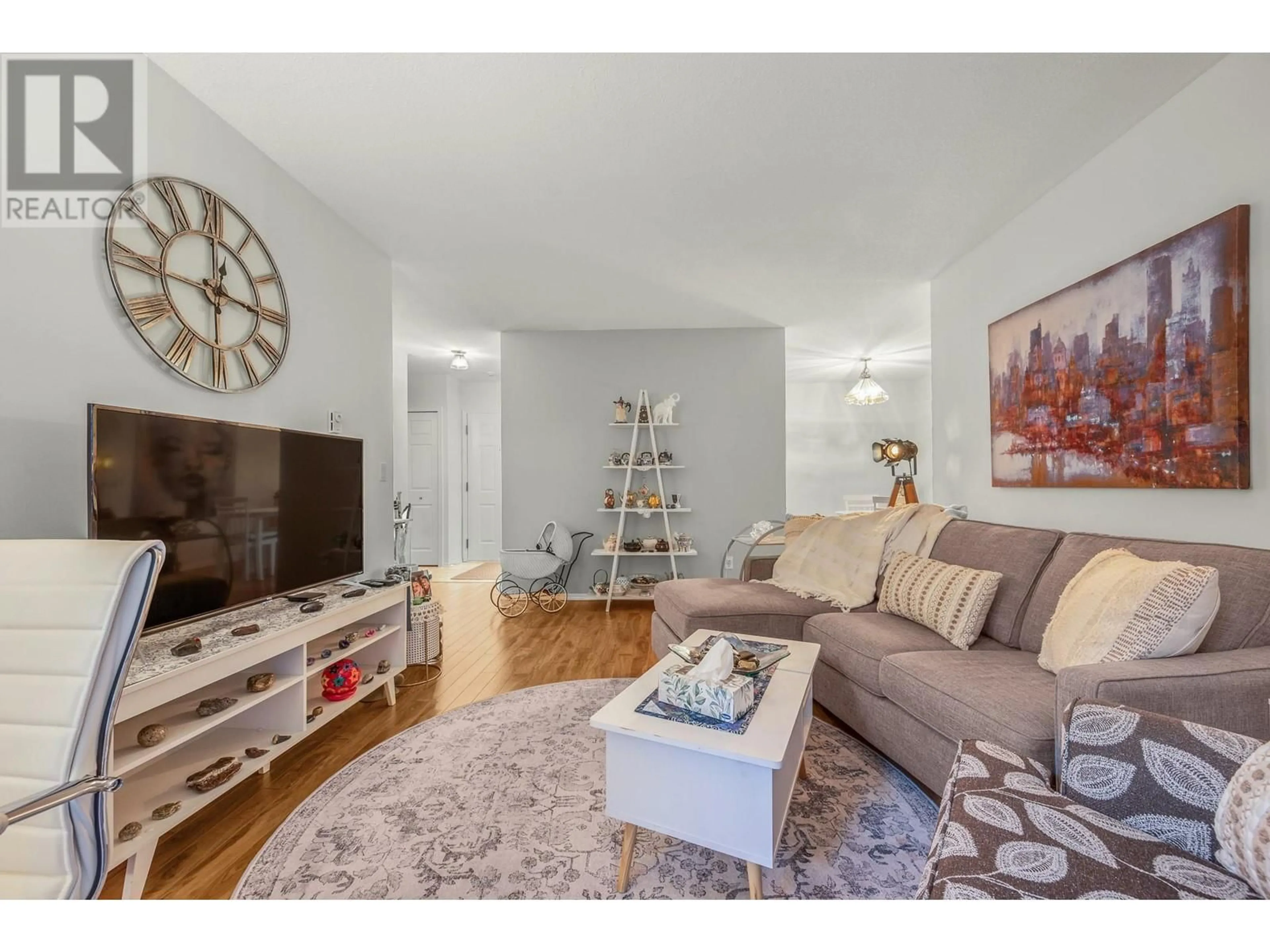 Living room with furniture, wood/laminate floor for 104 - 3609 30 AVENUE, Vernon British Columbia V1T2E6