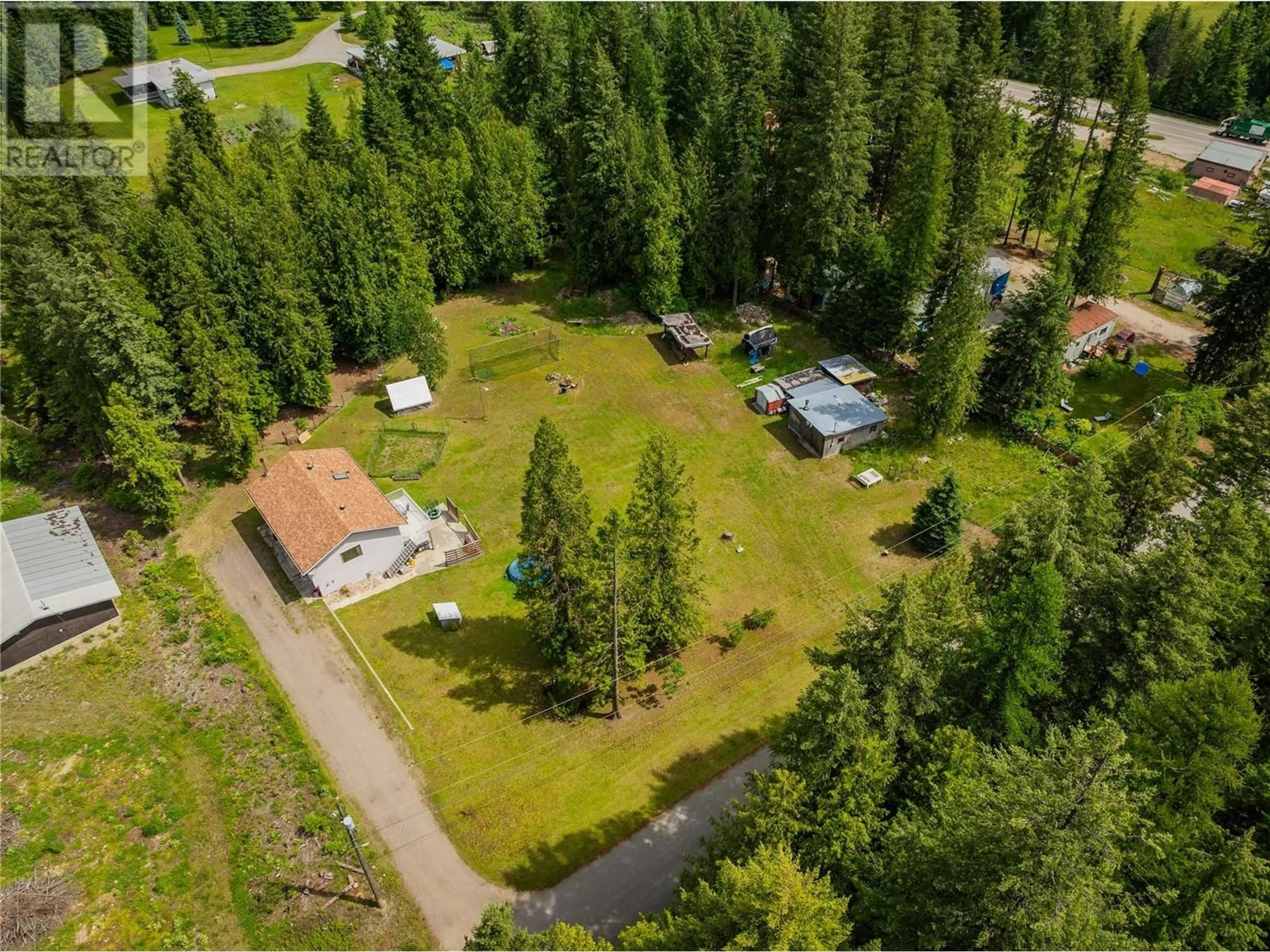 A pic from outside/outdoor area/front of a property/back of a property/a pic from drone, forest/trees view for 982 Kelly Drive, Castlegar British Columbia V1N4P5