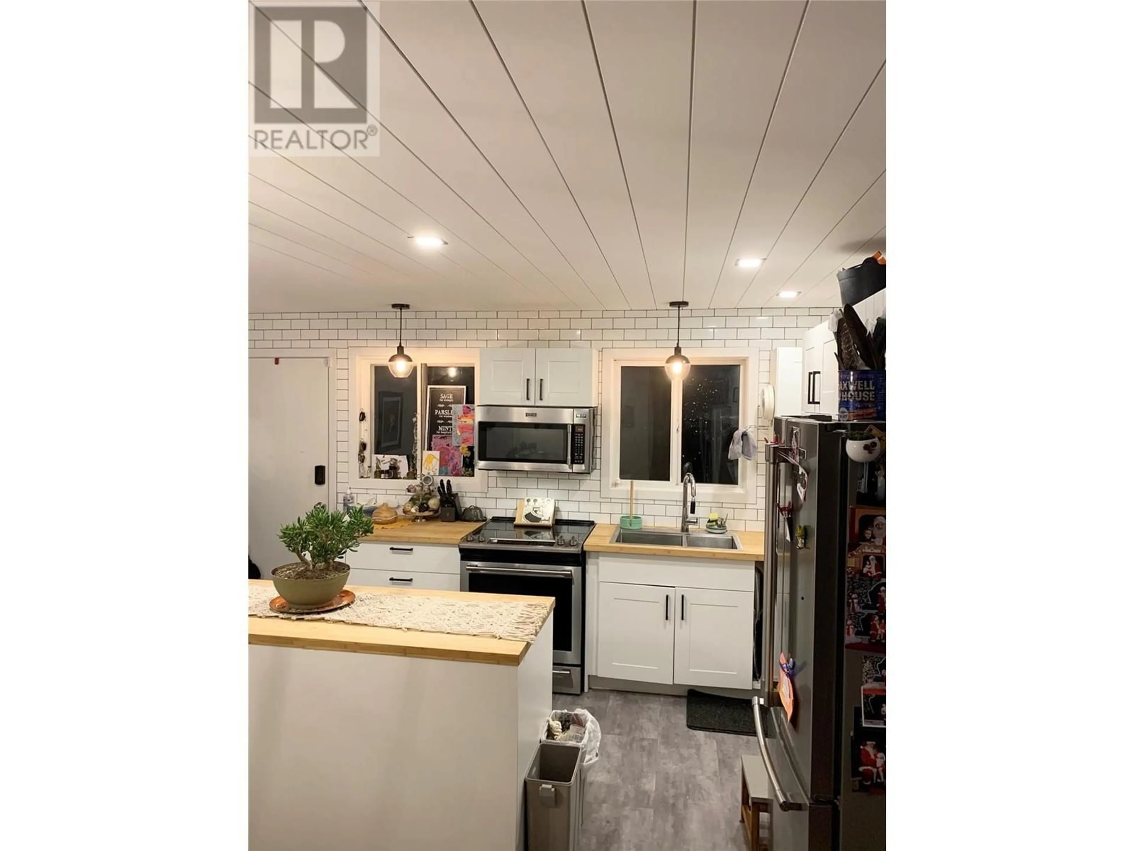 Open concept kitchen, wood/laminate floor for 9718 QUINPOOL Road, Summerland British Columbia V0H1Z0