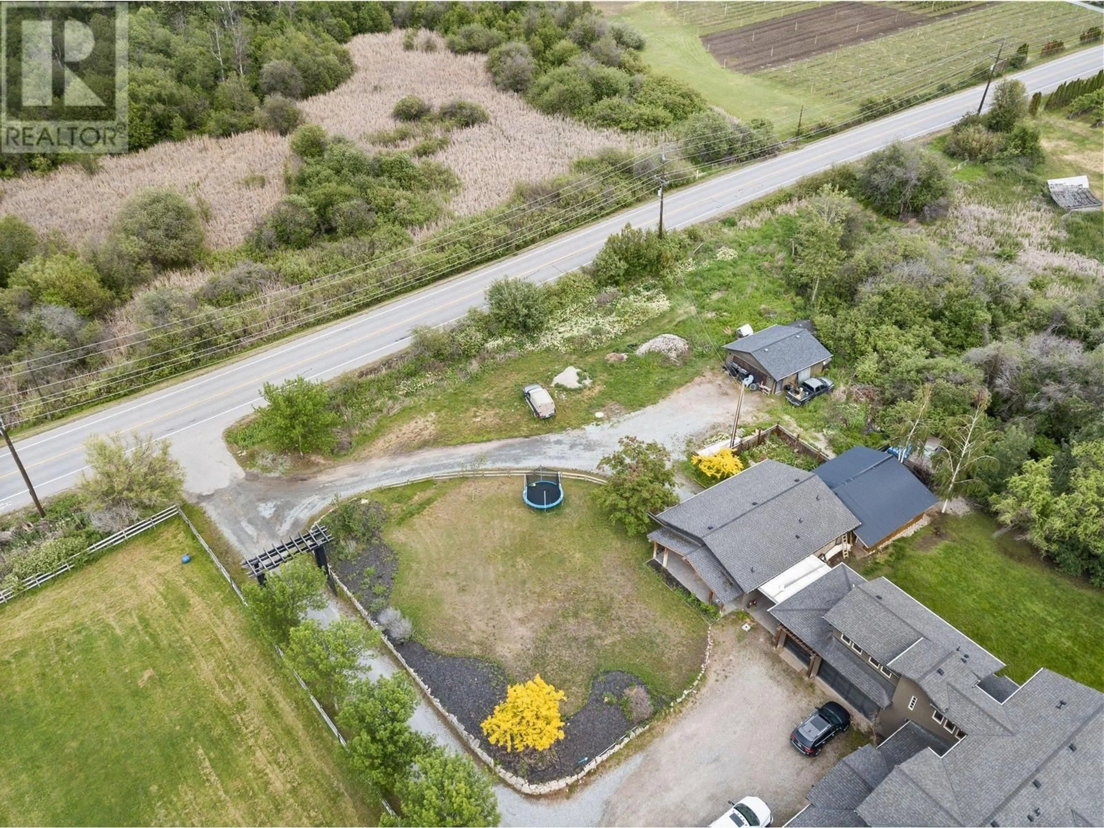 A pic from outside/outdoor area/front of a property/back of a property/a pic from drone, street for 3830 CASORSO ROAD, Kelowna British Columbia V1W4R7