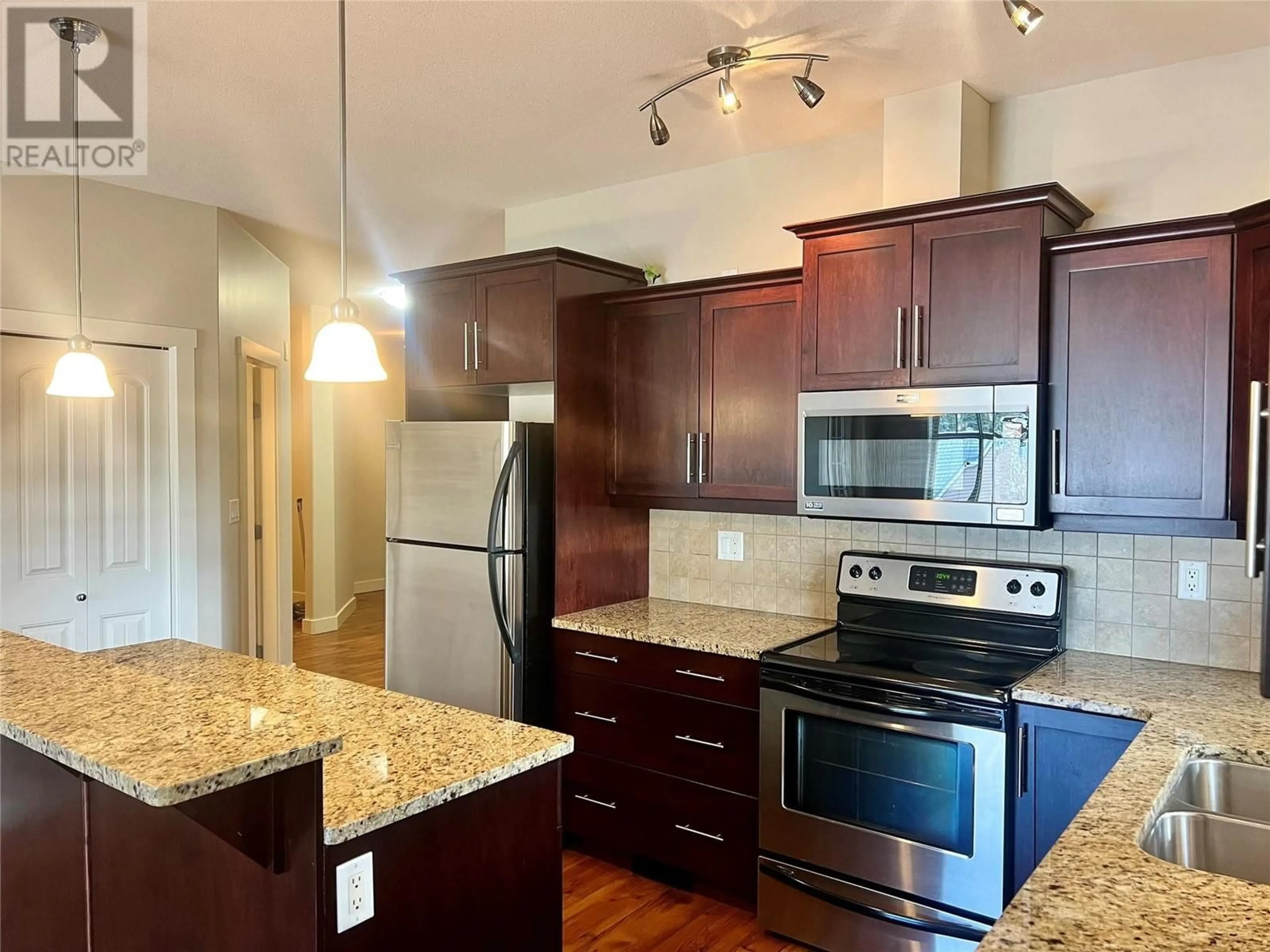 Open concept kitchen, wood/laminate floor for 13615 VICTORIA Road Unit# 303, Summerland British Columbia V0H1Z0