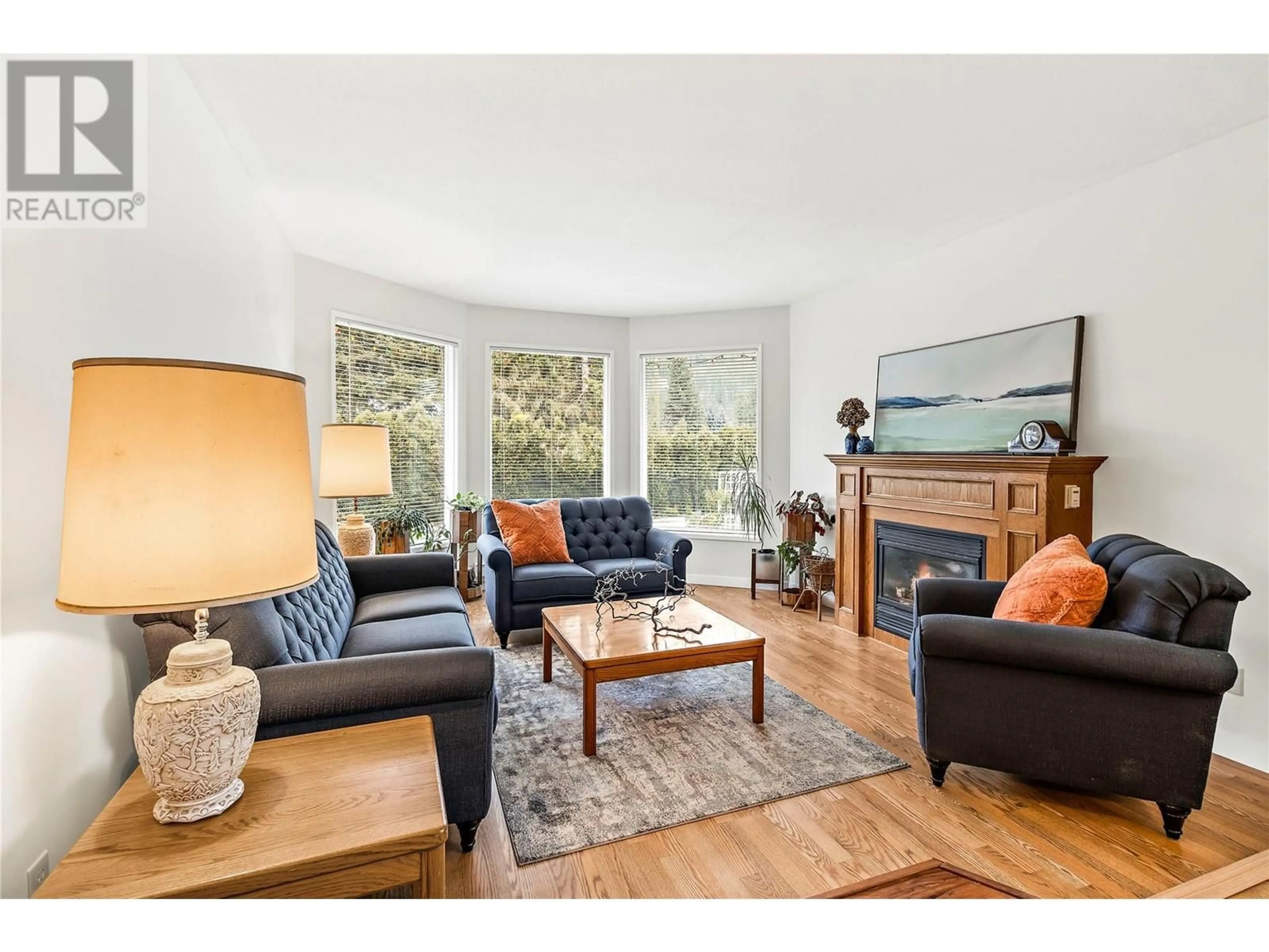 Living room with furniture, wood/laminate floor for 602 Birch Avenue, Sicamous British Columbia V0E2V0