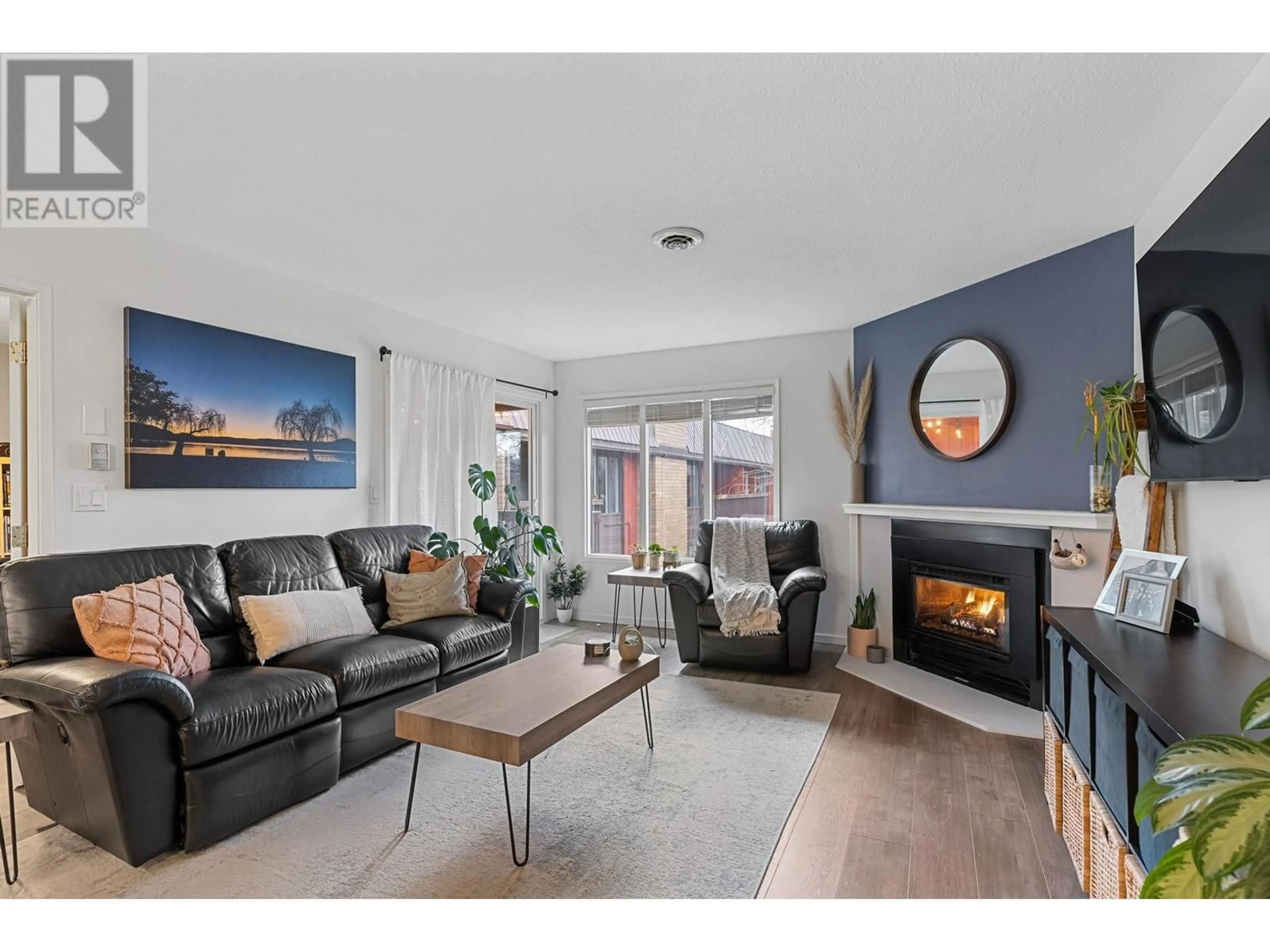 Living room with furniture, wood/laminate floor for 1870 Parkinson Way Unit# 210, Kelowna British Columbia V1Y8C9