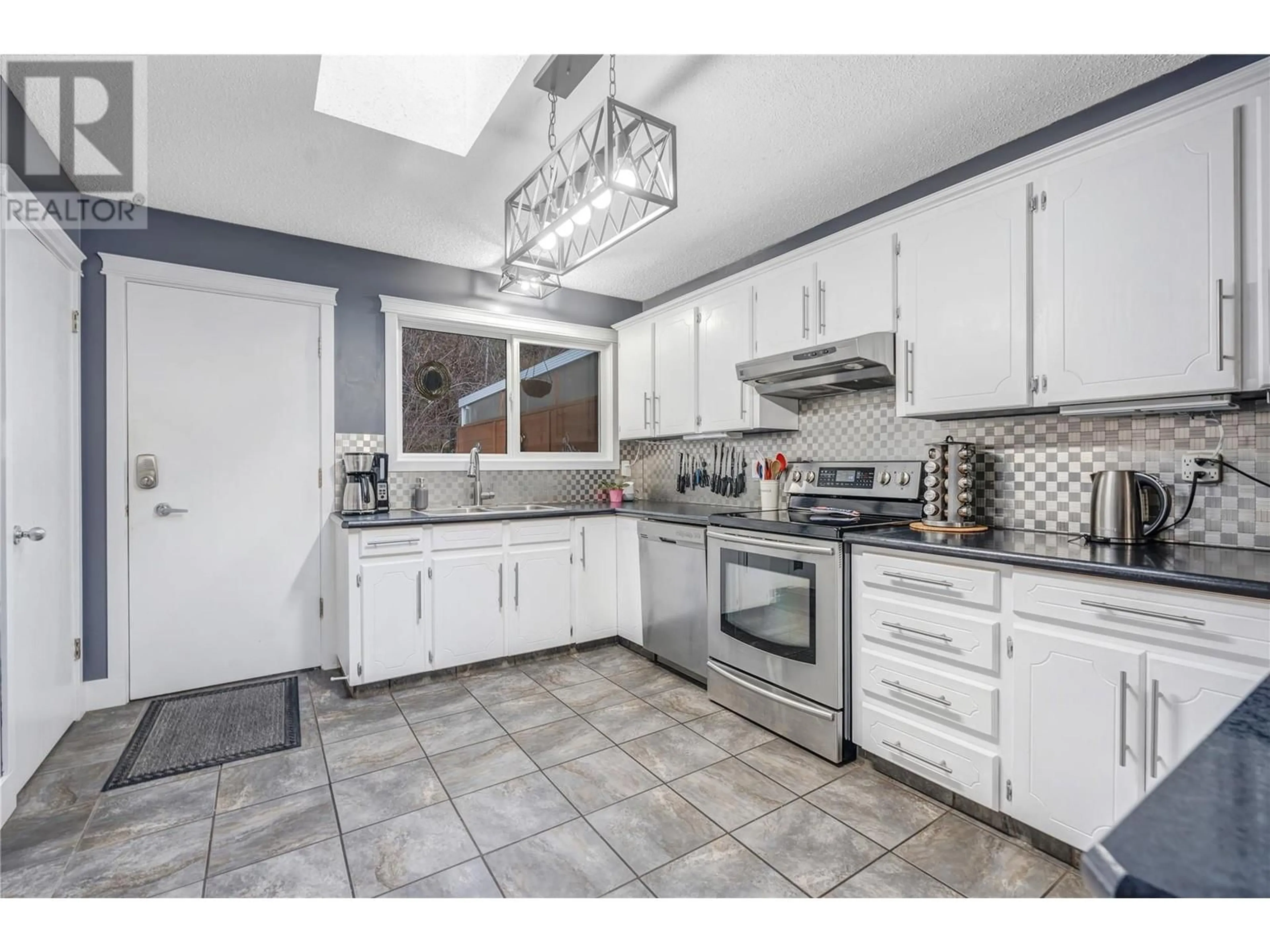 Open concept kitchen, ceramic/tile floor for 1568 Penticton Avenue, Penticton British Columbia V2A8N7