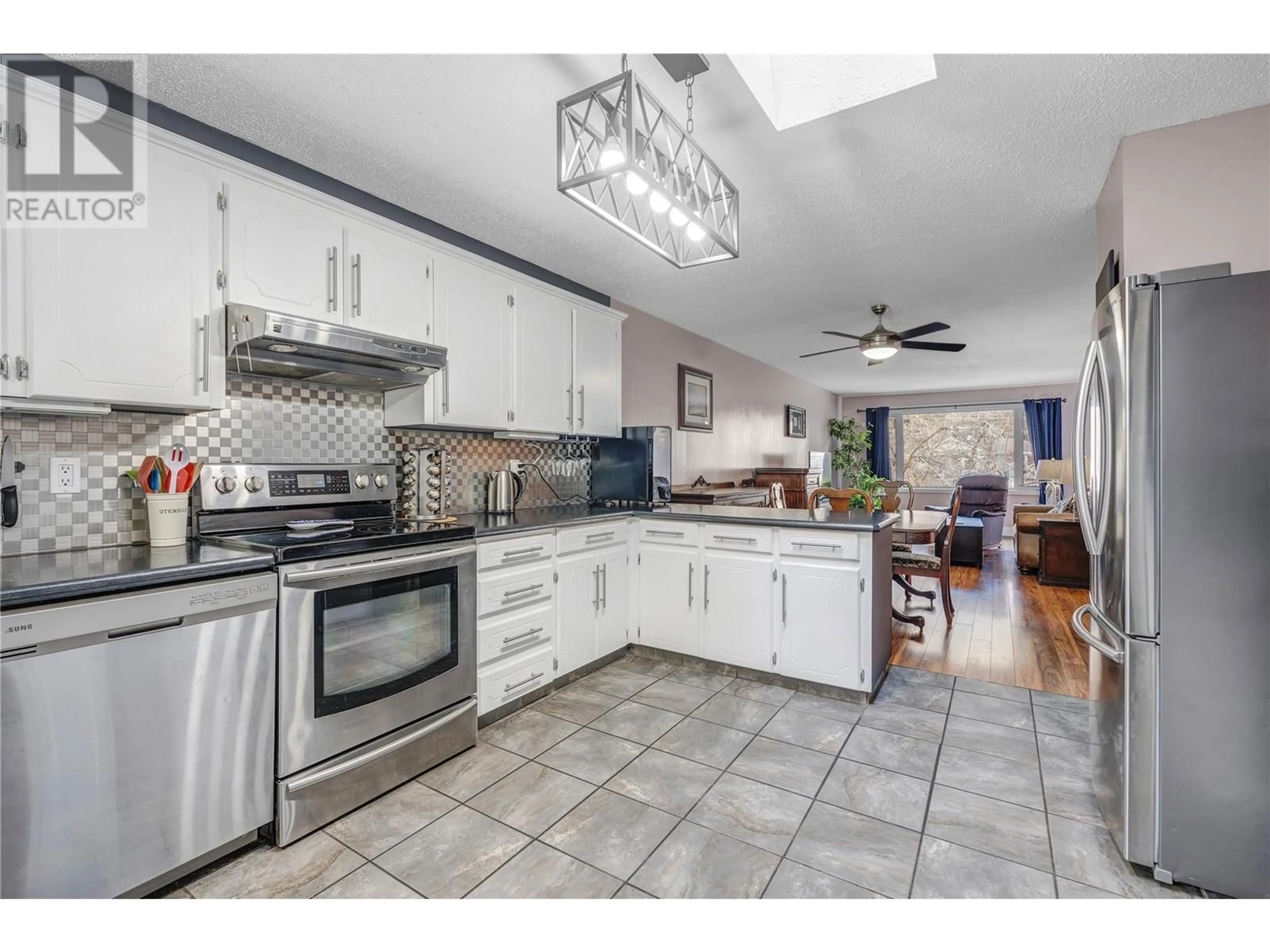 Open concept kitchen, ceramic/tile floor for 1568 Penticton Avenue, Penticton British Columbia V2A8N7