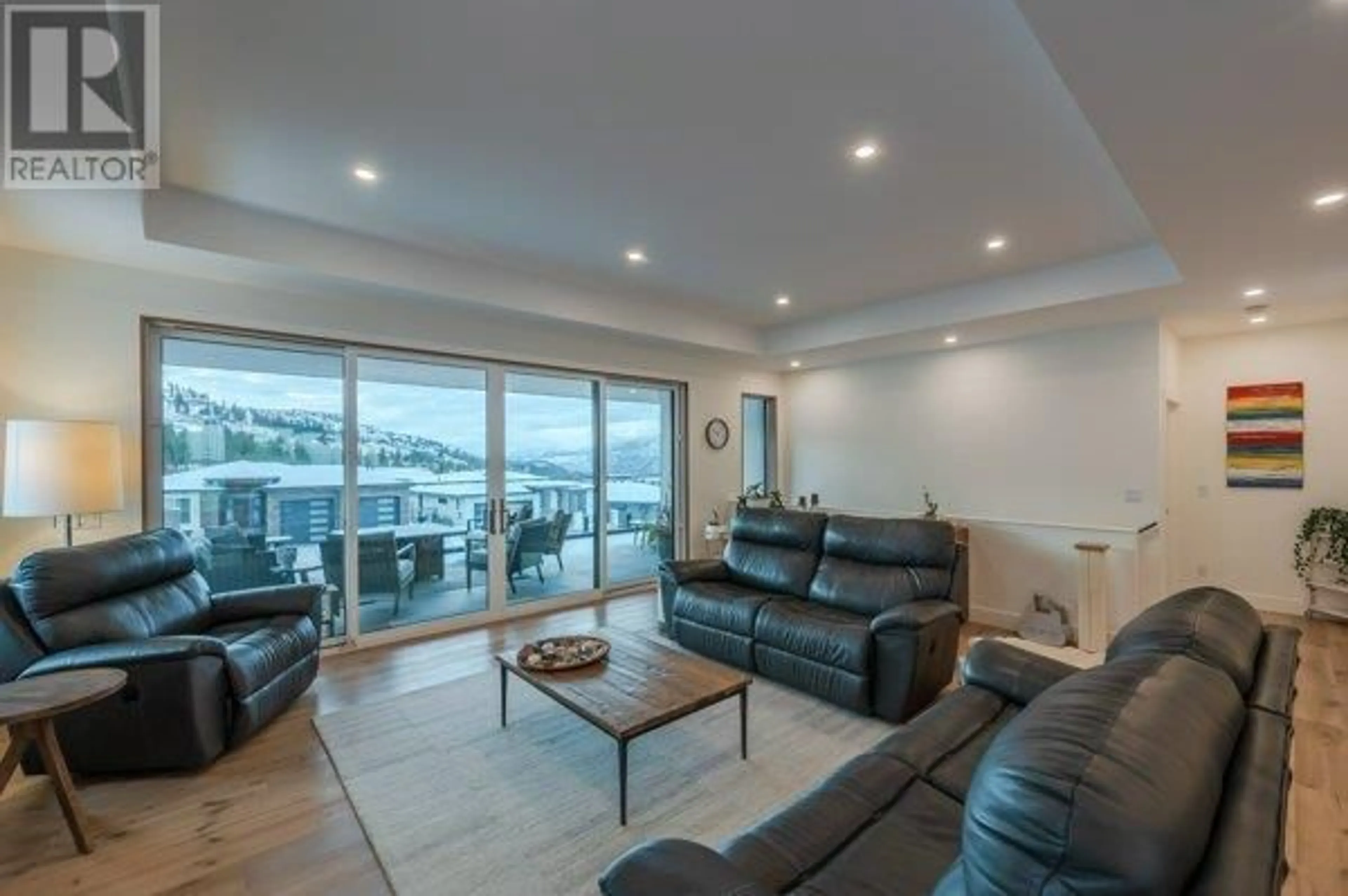 Living room with furniture, wood/laminate floor for 1949 Harris Drive, Penticton British Columbia V2A0C8