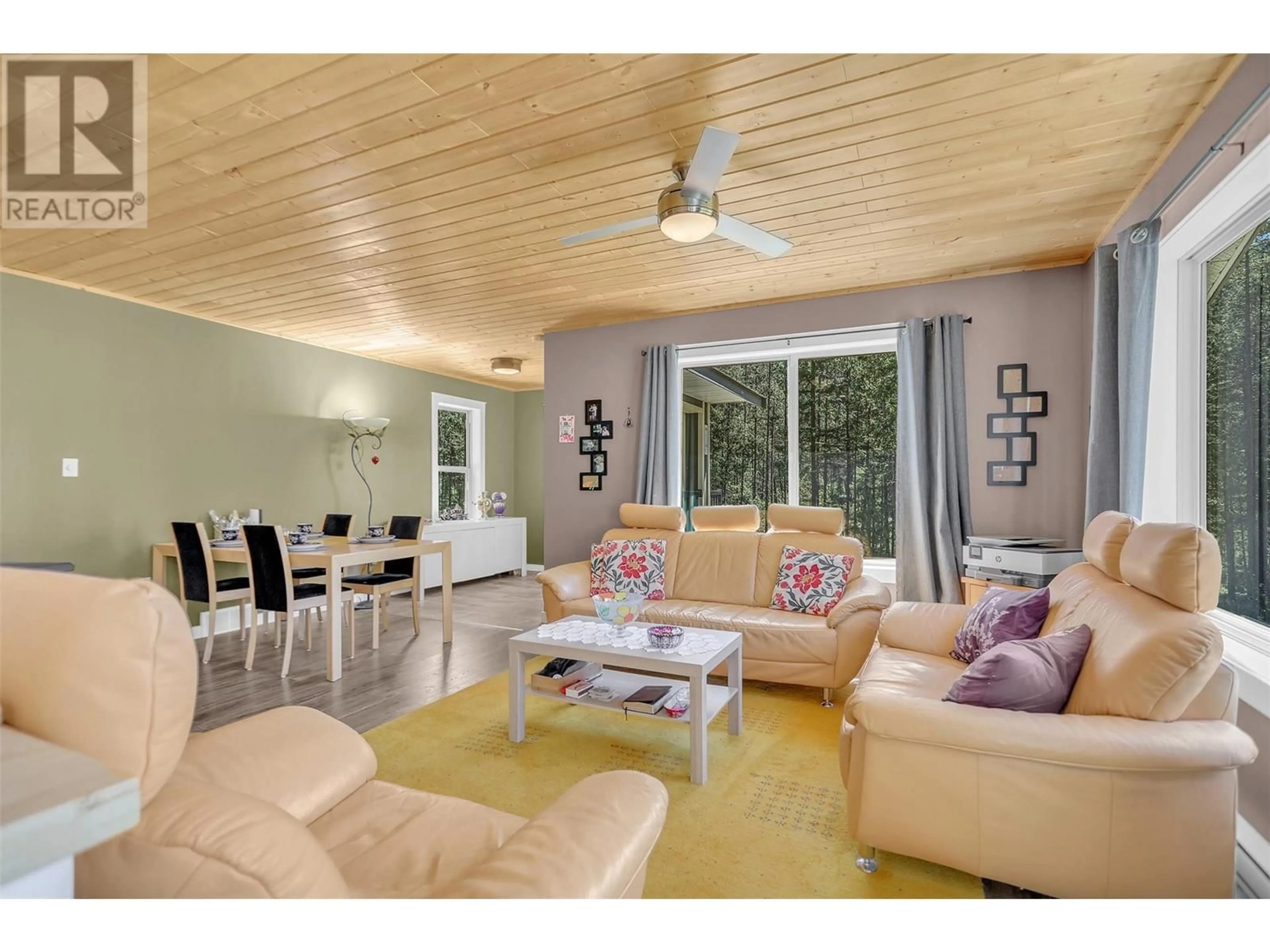 Living room with furniture, wood/laminate floor for 3445 Blythe-Rhone Road, Westbridge British Columbia V0H1Y0