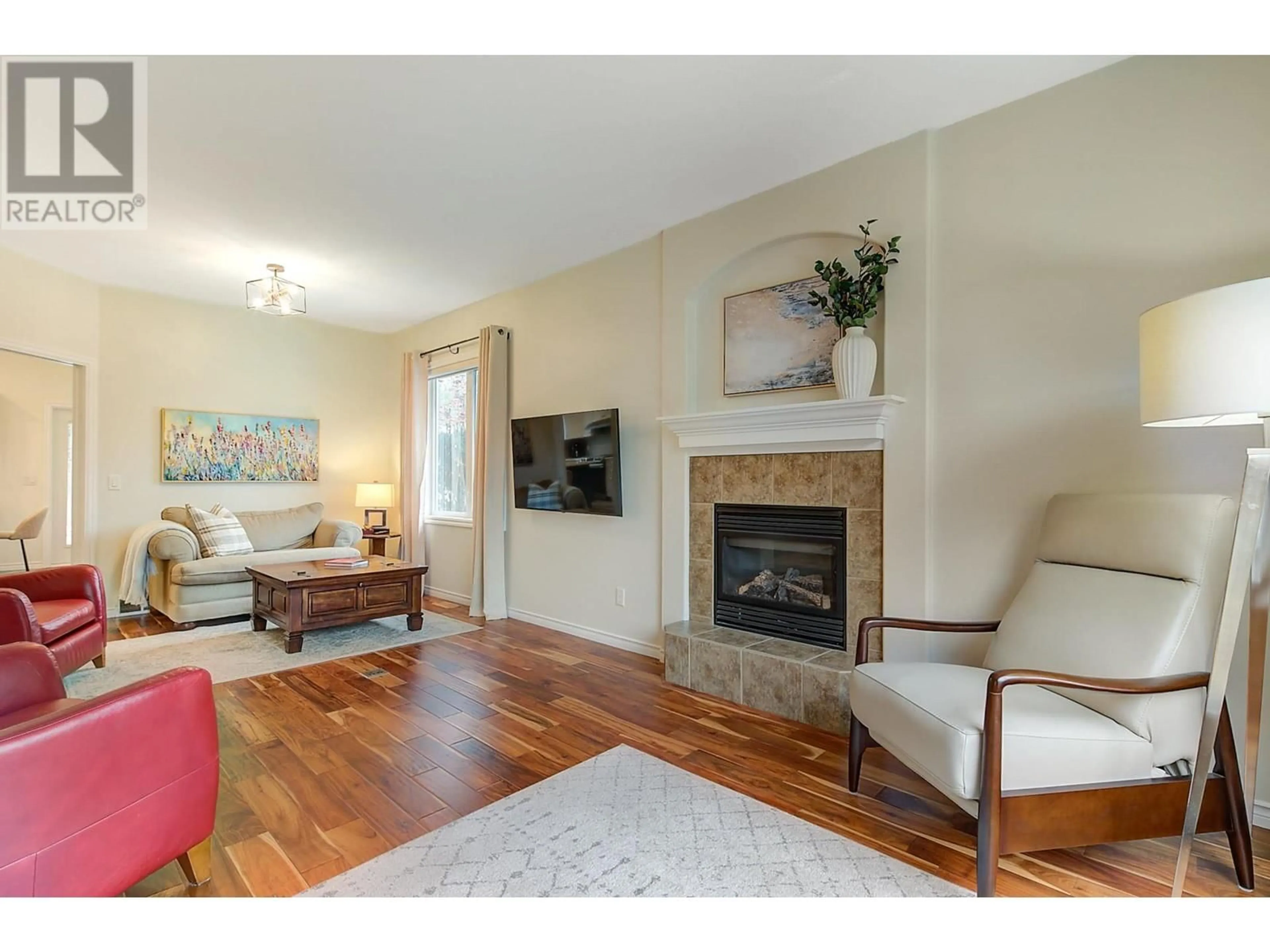 Living room with furniture, wood/laminate floor for 4141 Gallaghers Forest Road S, Kelowna British Columbia V1W5E4