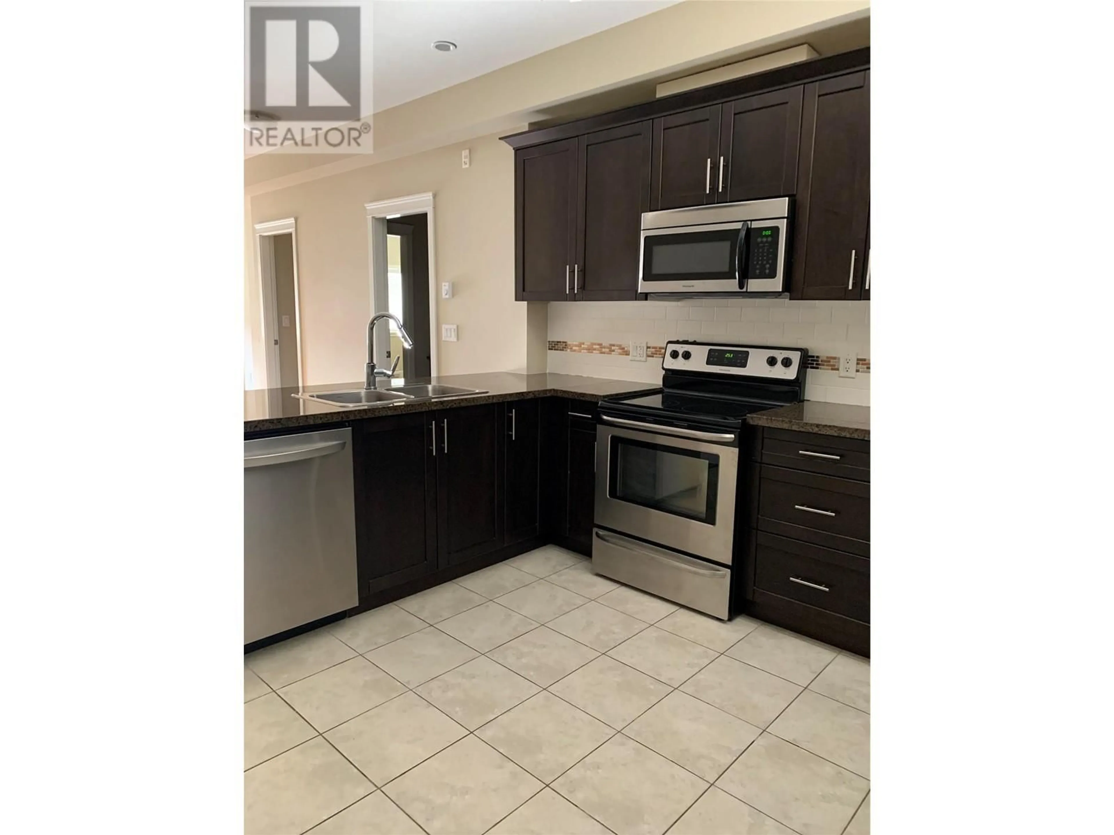 Open concept kitchen, ceramic/tile floor for 2799 CLAPPERTON Avenue Unit# 205, Merritt British Columbia V1K1A2