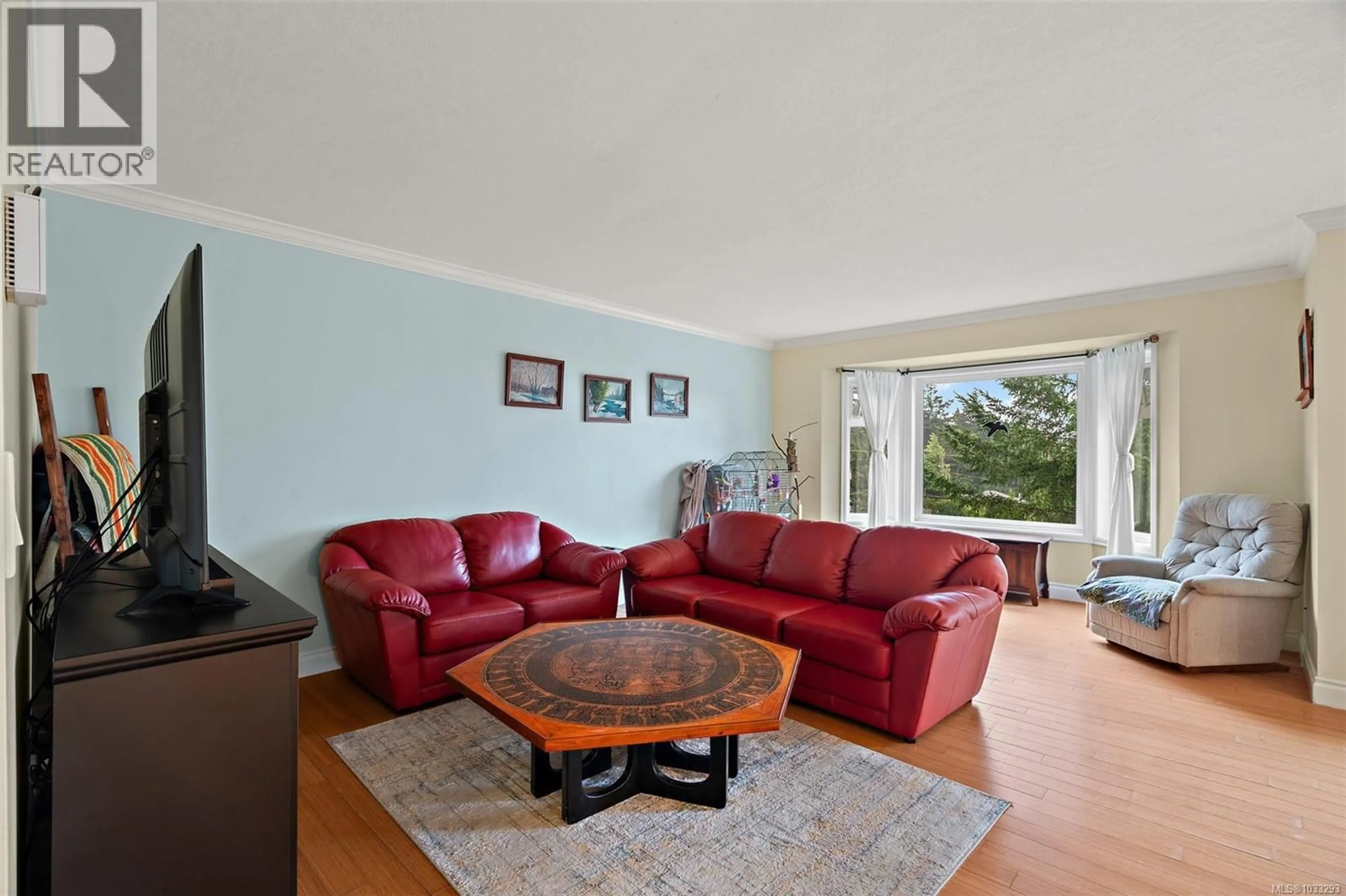 Living room with furniture, wood/laminate floor for 2197 HENLYN DRIVE, Sooke British Columbia V9Z0N5