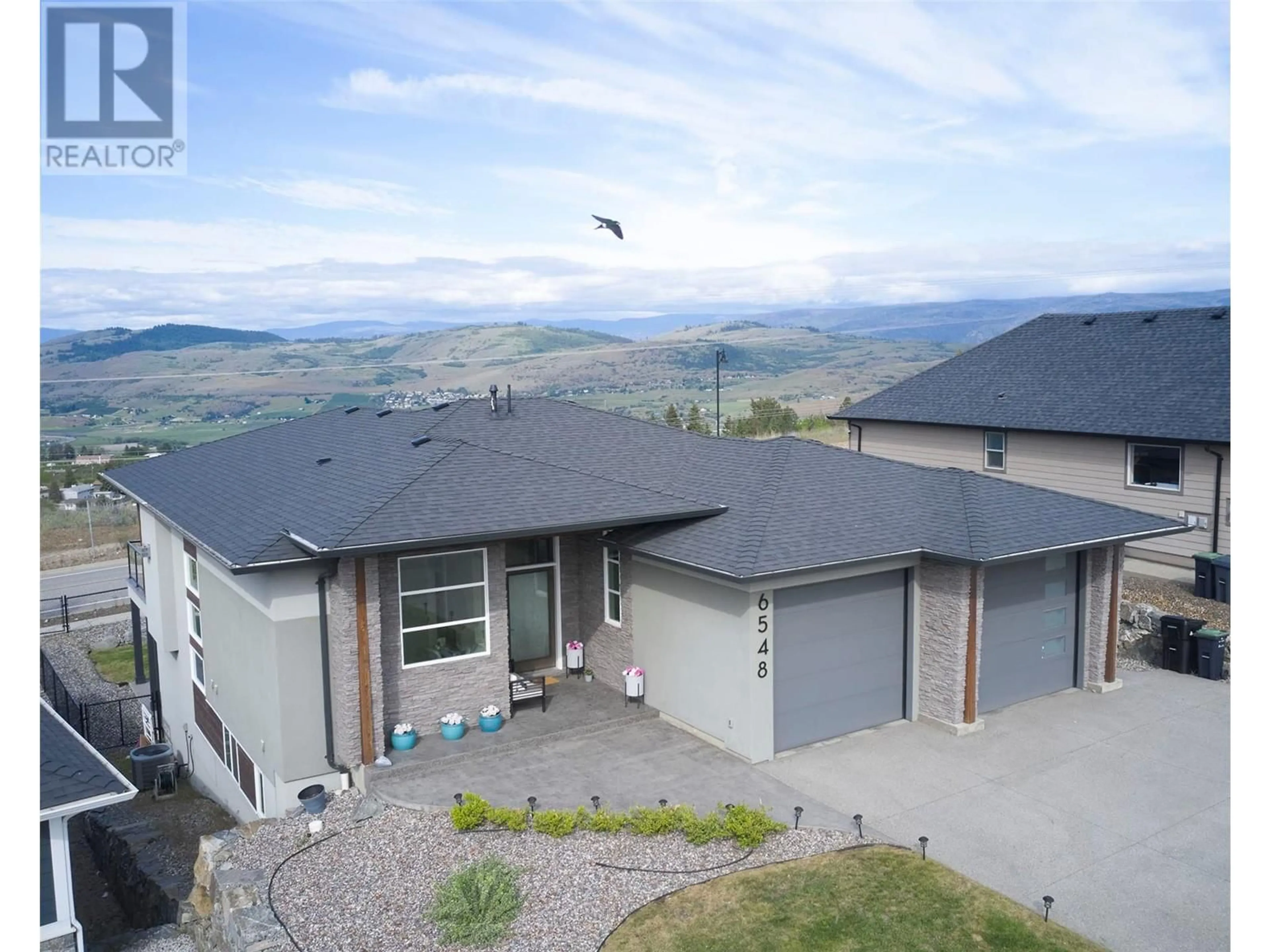 A pic from outside/outdoor area/front of a property/back of a property/a pic from drone, mountain view for 6548 Blackcomb Place, Vernon British Columbia V1B4E1