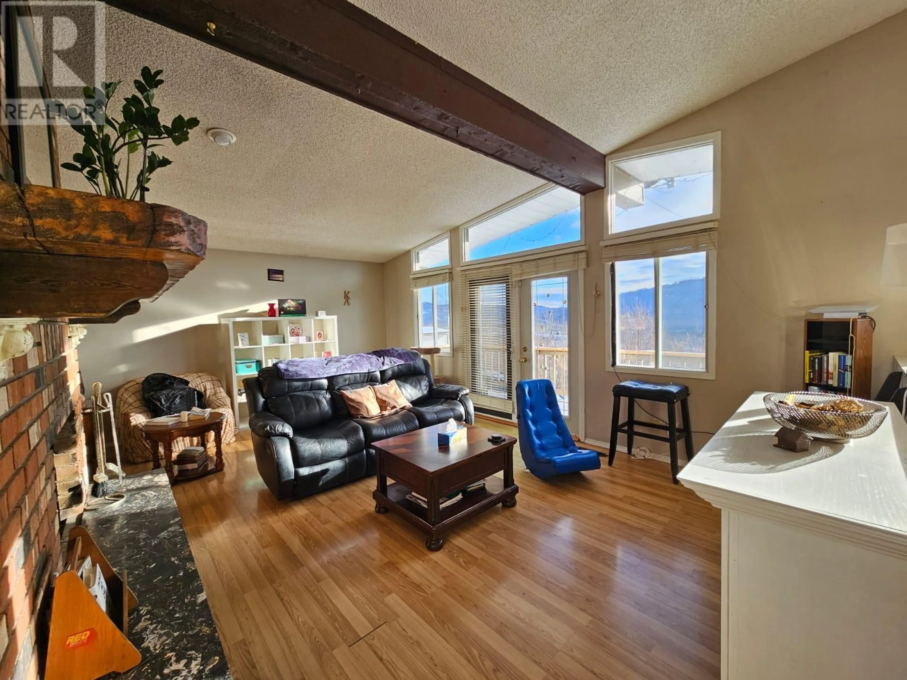 Living room with furniture, wood/laminate floor for 6340 Campbell Road, Chetwynd British Columbia V0C1J0