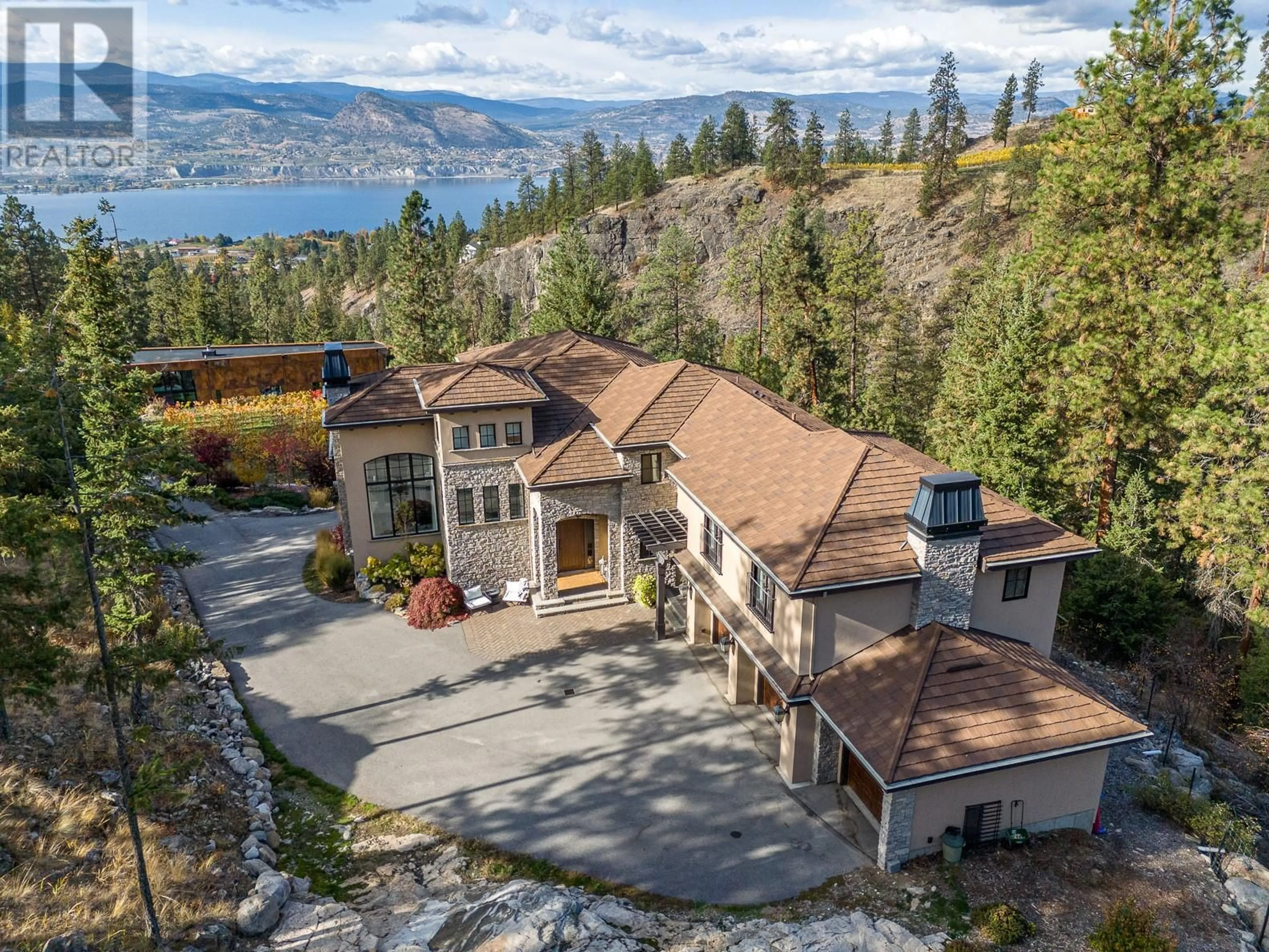 A pic from outside/outdoor area/front of a property/back of a property/a pic from drone, water/lake/river/ocean view for 130 Slate Place, Naramata British Columbia V0H1N1