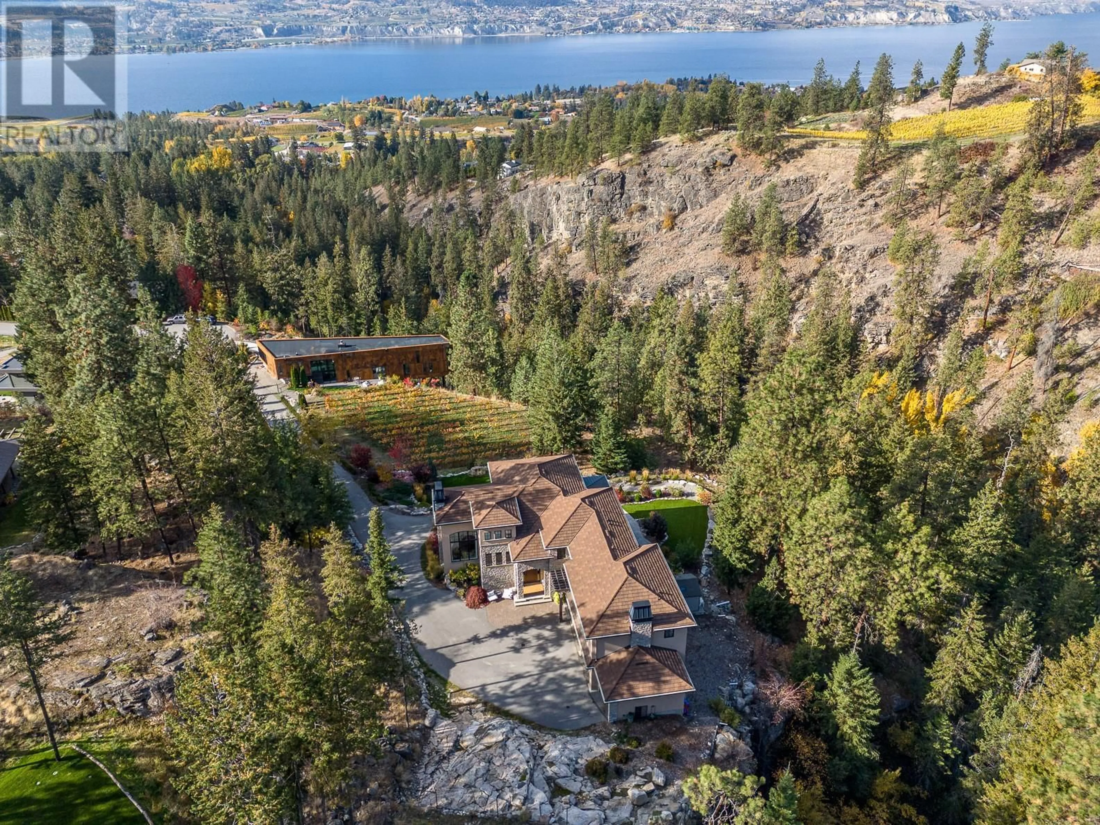 A pic from outside/outdoor area/front of a property/back of a property/a pic from drone, water/lake/river/ocean view for 130 Slate Place, Naramata British Columbia V0H1N1