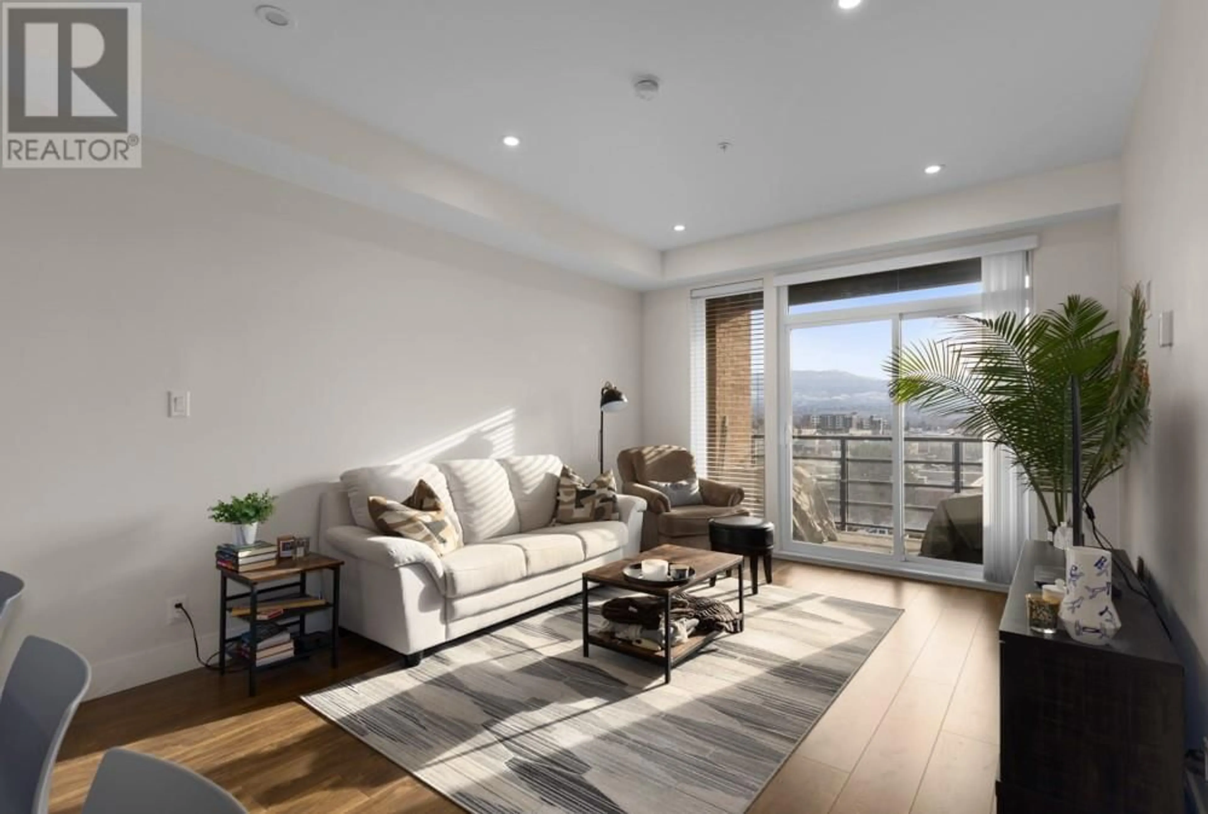 Living room with furniture, wood/laminate floor for 1925 Enterprise Way Unit# 510, Kelowna British Columbia V1Y0J8