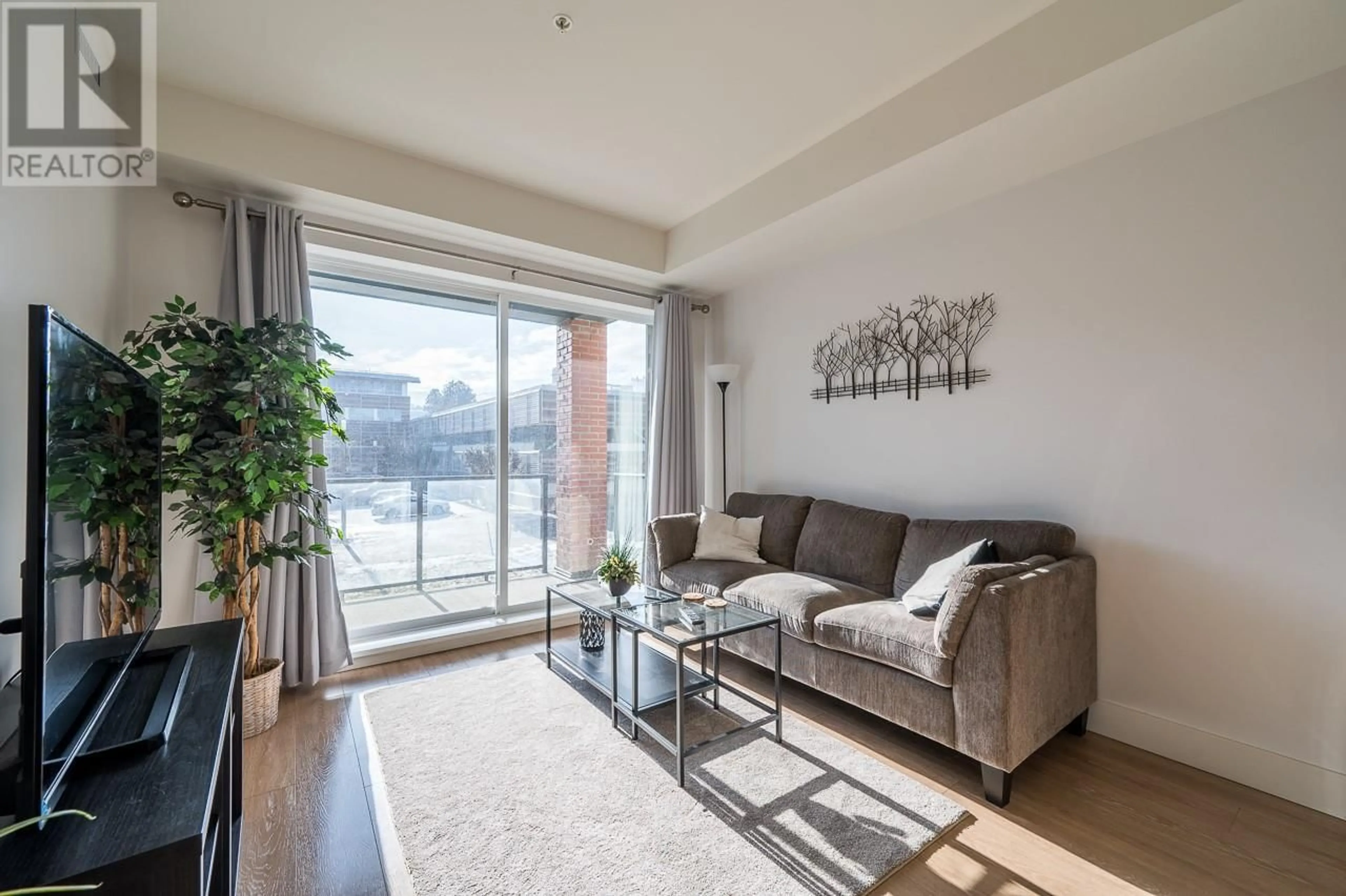 Living room with furniture, wood/laminate floor for 885 University Drive Unit# 209, Kamloops British Columbia V2C0K2