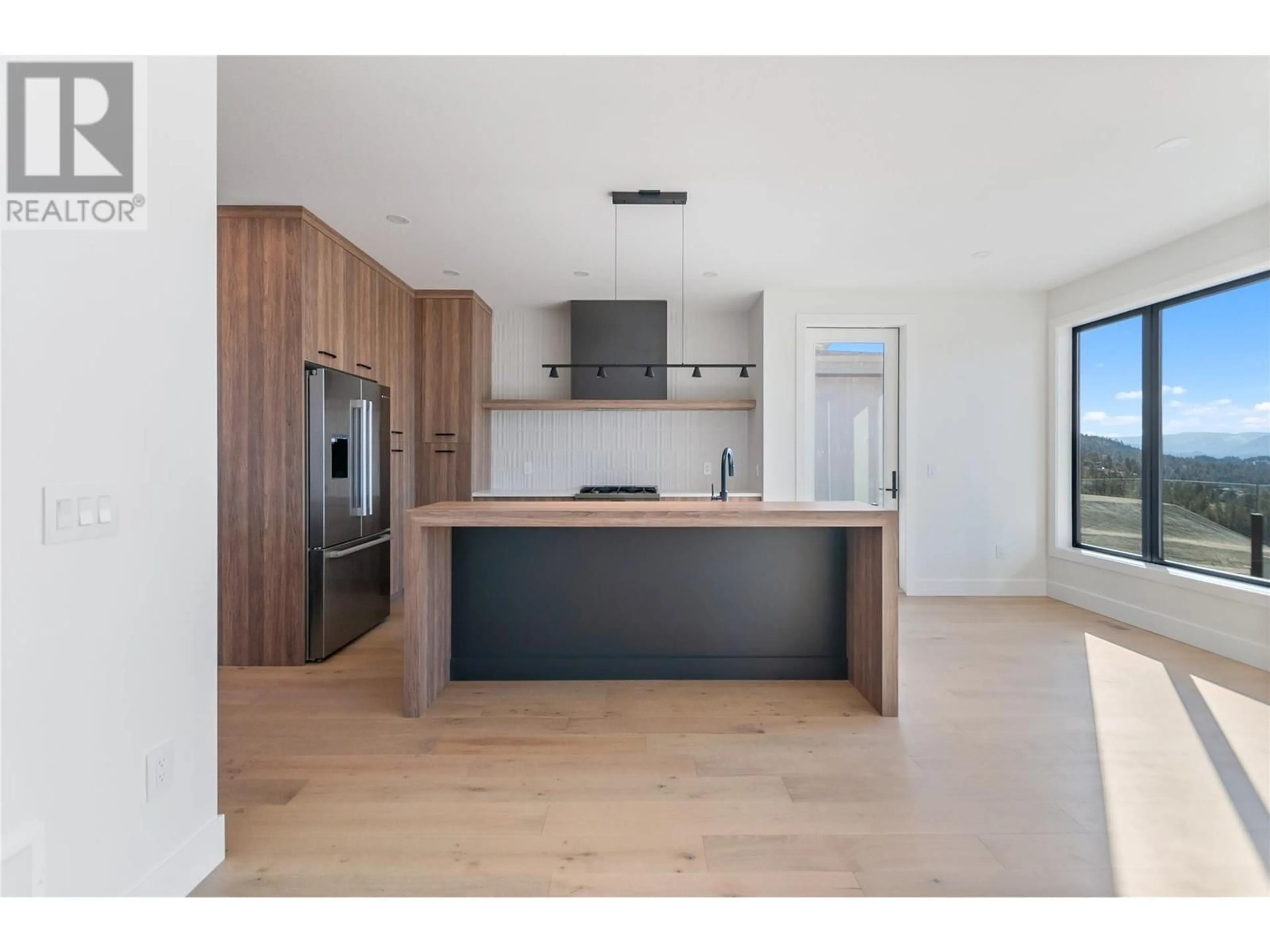 Open concept kitchen, wood/laminate floor for 1075 Elk Street, Penticton British Columbia V2A0C9