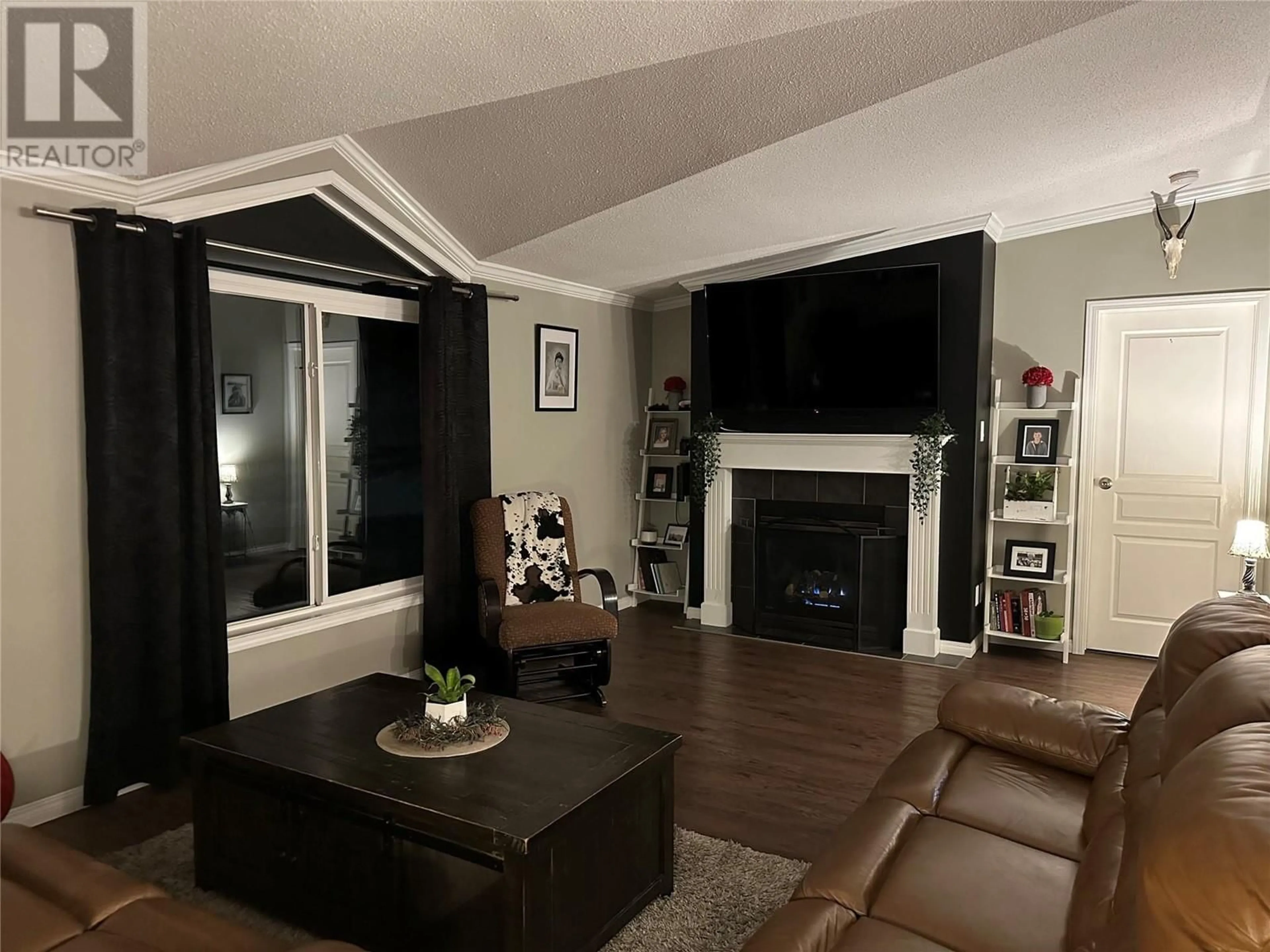 Living room with furniture, wood/laminate floor for 3720 206 Road, Dawson Creek British Columbia V1G0C2