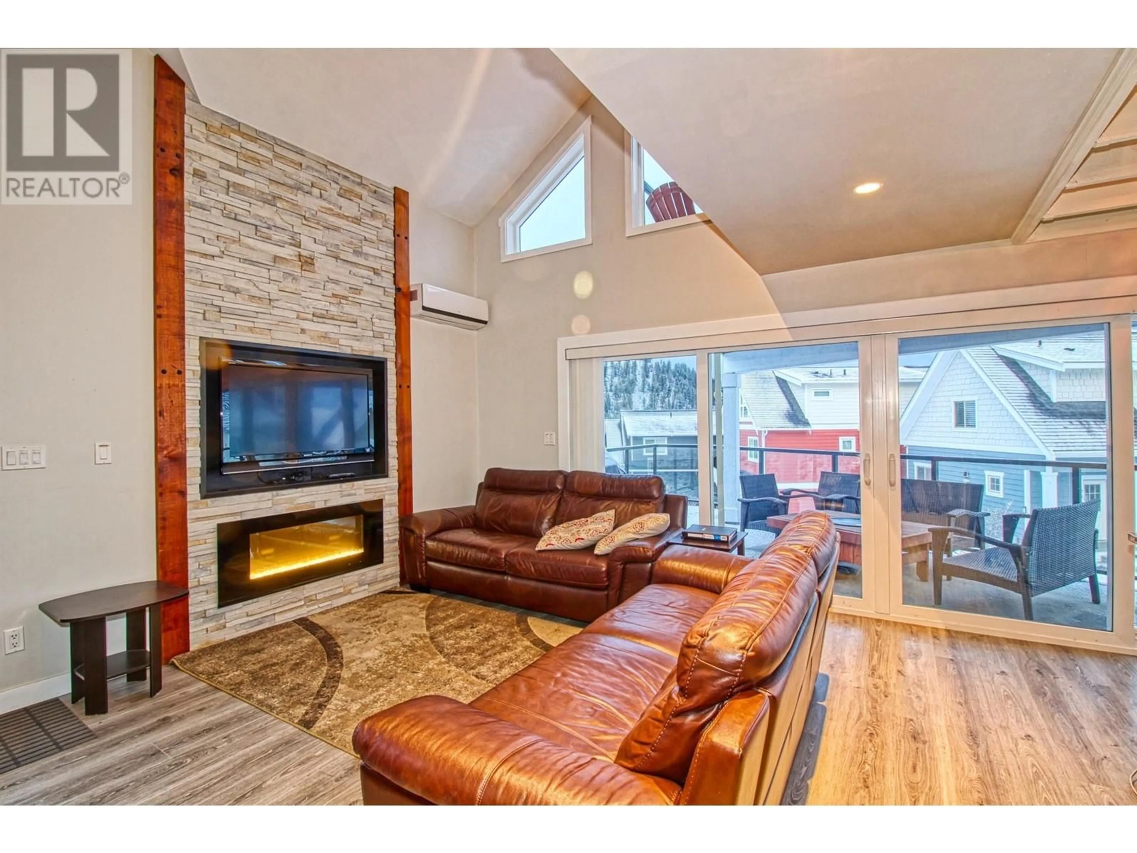 Living room with furniture, wood/laminate floor for 168 - 6824 SANTIAGO LOOP, Kelowna British Columbia V1Z3R8